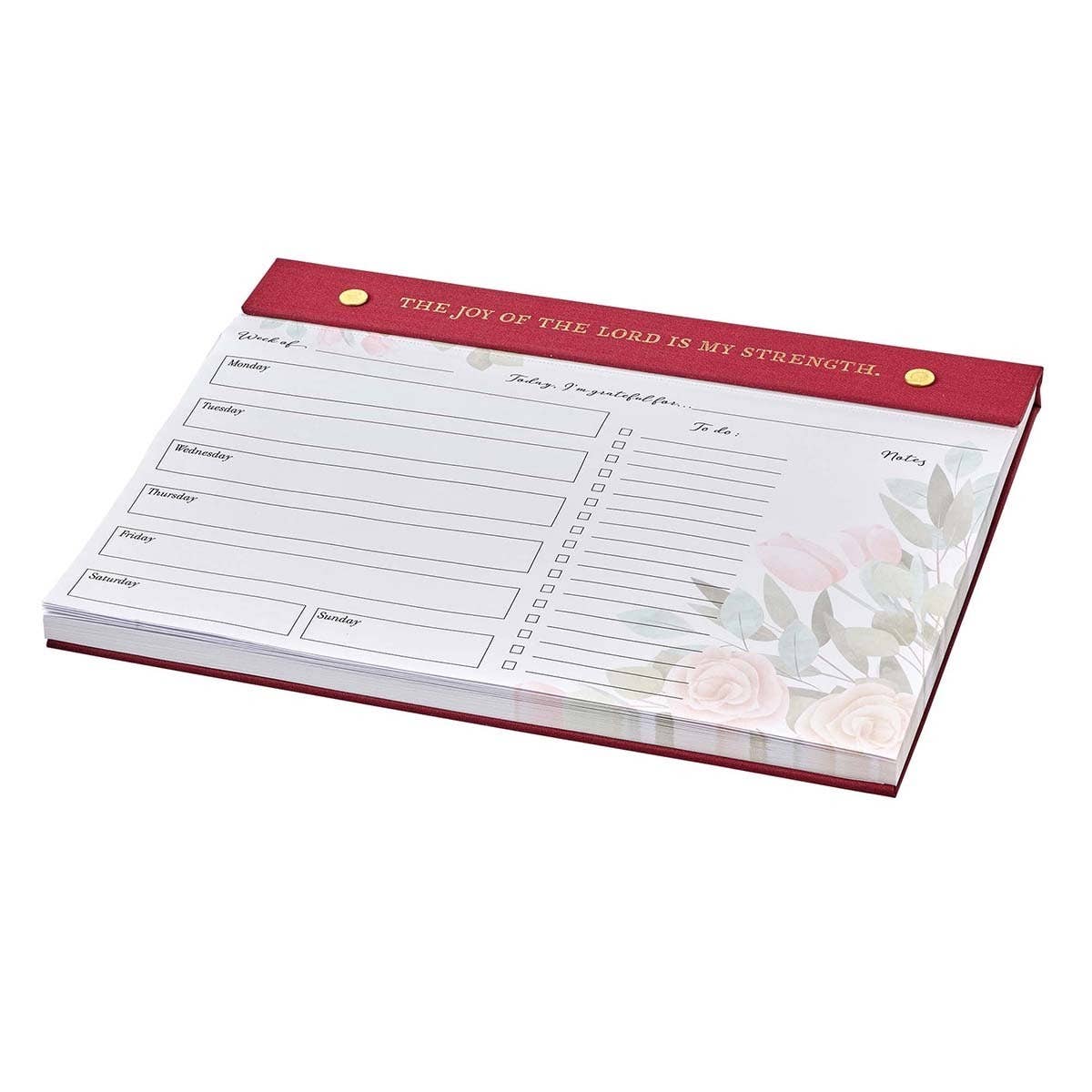 Undated planner pad from Christian Art Gifts with burgundy cover, featuring inspirational "Joy of the Lord" design and daily planner pages.