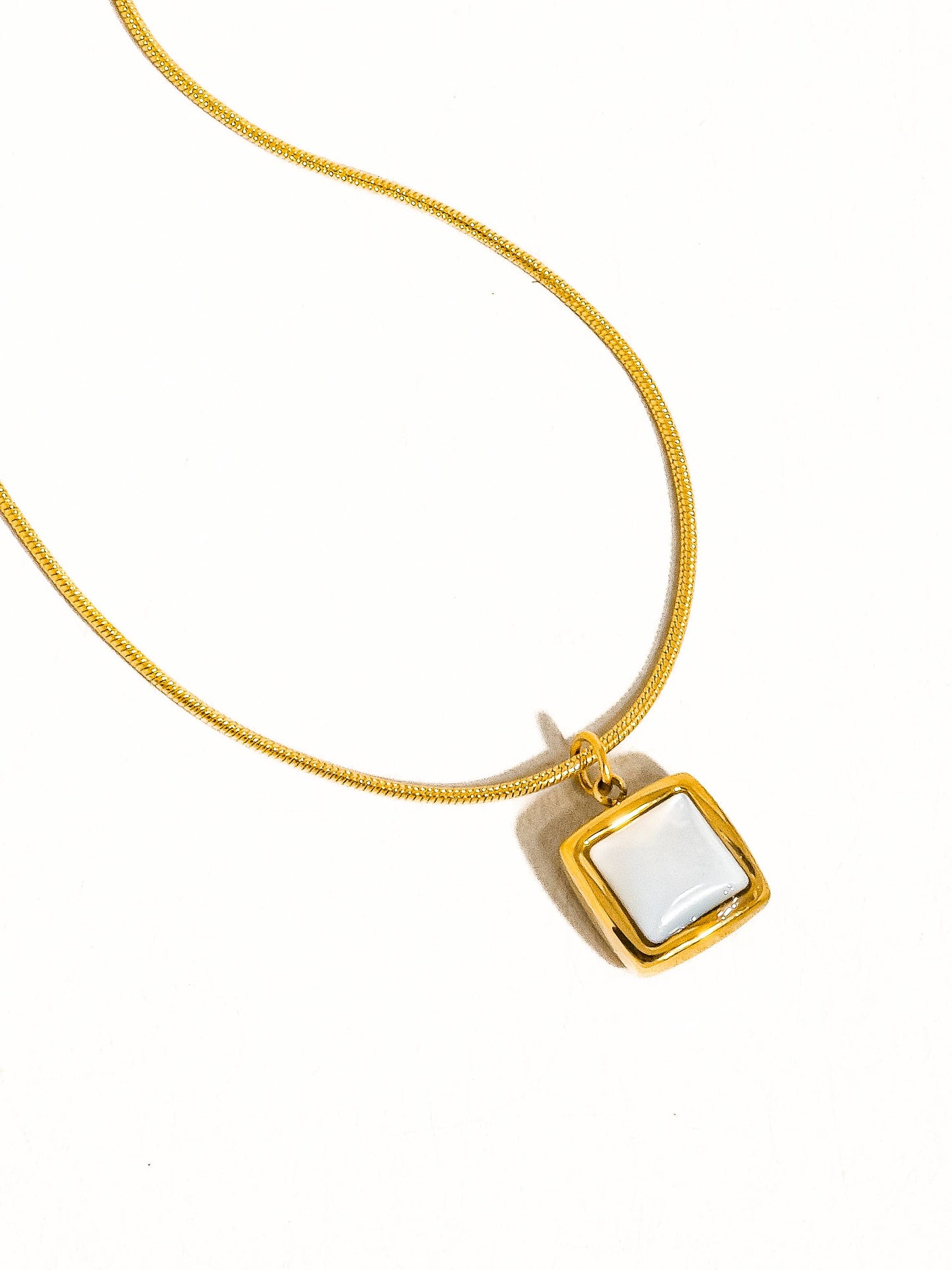 18K gold non-tarnish square shell necklace by Flanerie by MAIQ featuring a sleek, elegant square shell pendant on a gold chain