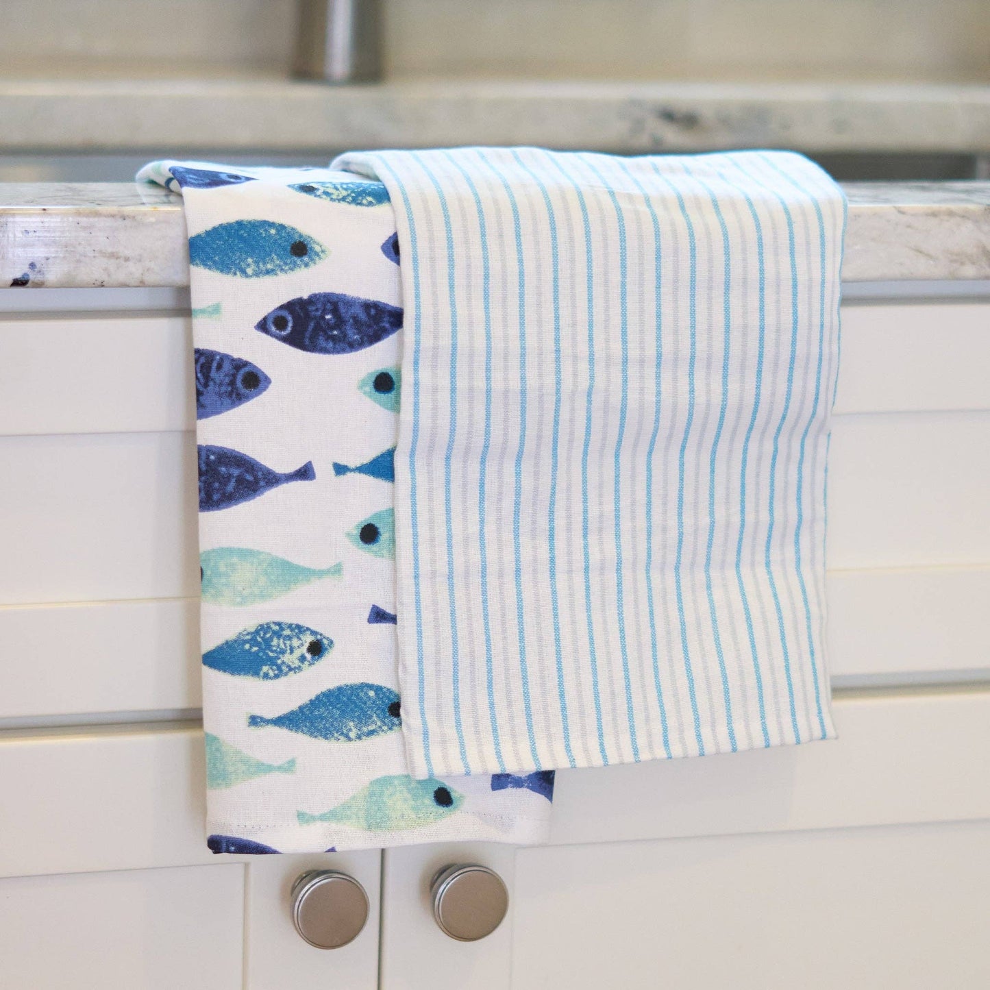 Three seafoam stripe tea towels from Howard's 3-piece set, featuring soft fabric and vibrant coastal-inspired stripe patterns.