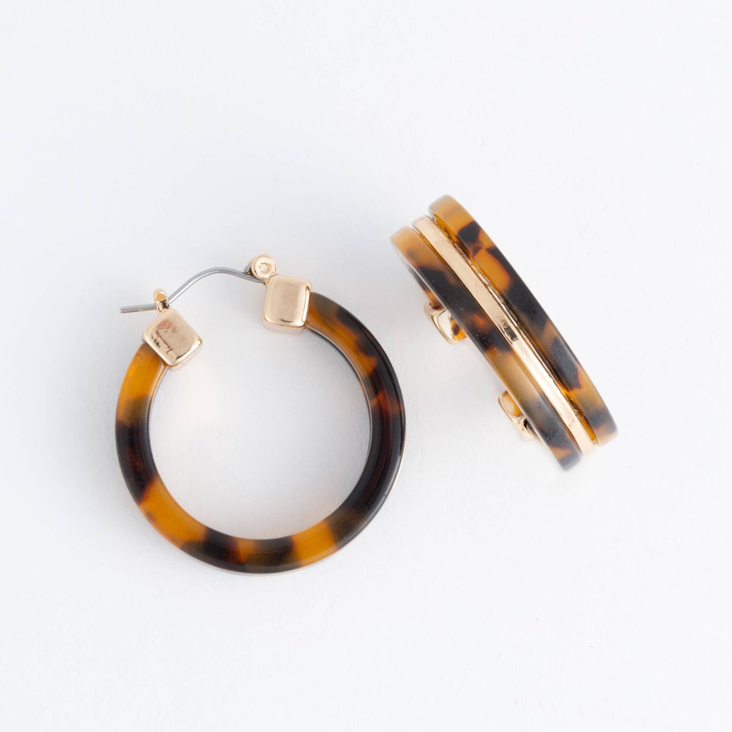 Howard's Sloane Tortoiseshell Circle Acrylic Hoop Earring showing a round tortoise pattern and gold-tone accents.