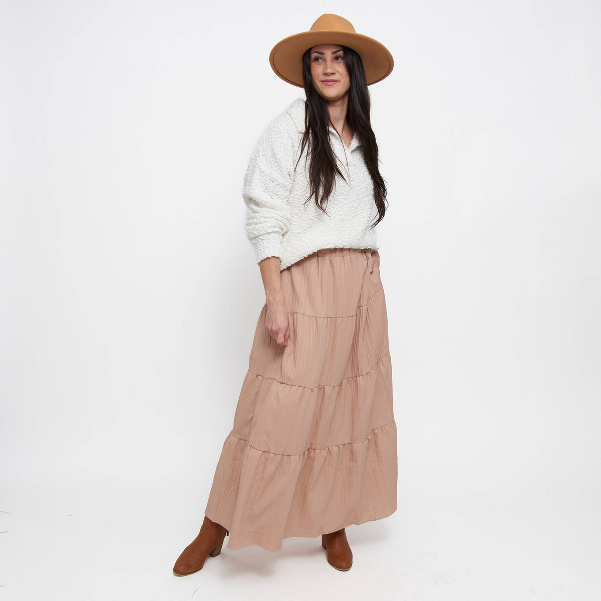 Howard's McKay tiered rosewater maxi skirt with pockets, featuring a flowing design and soft fabric in a pastel rosewater color.