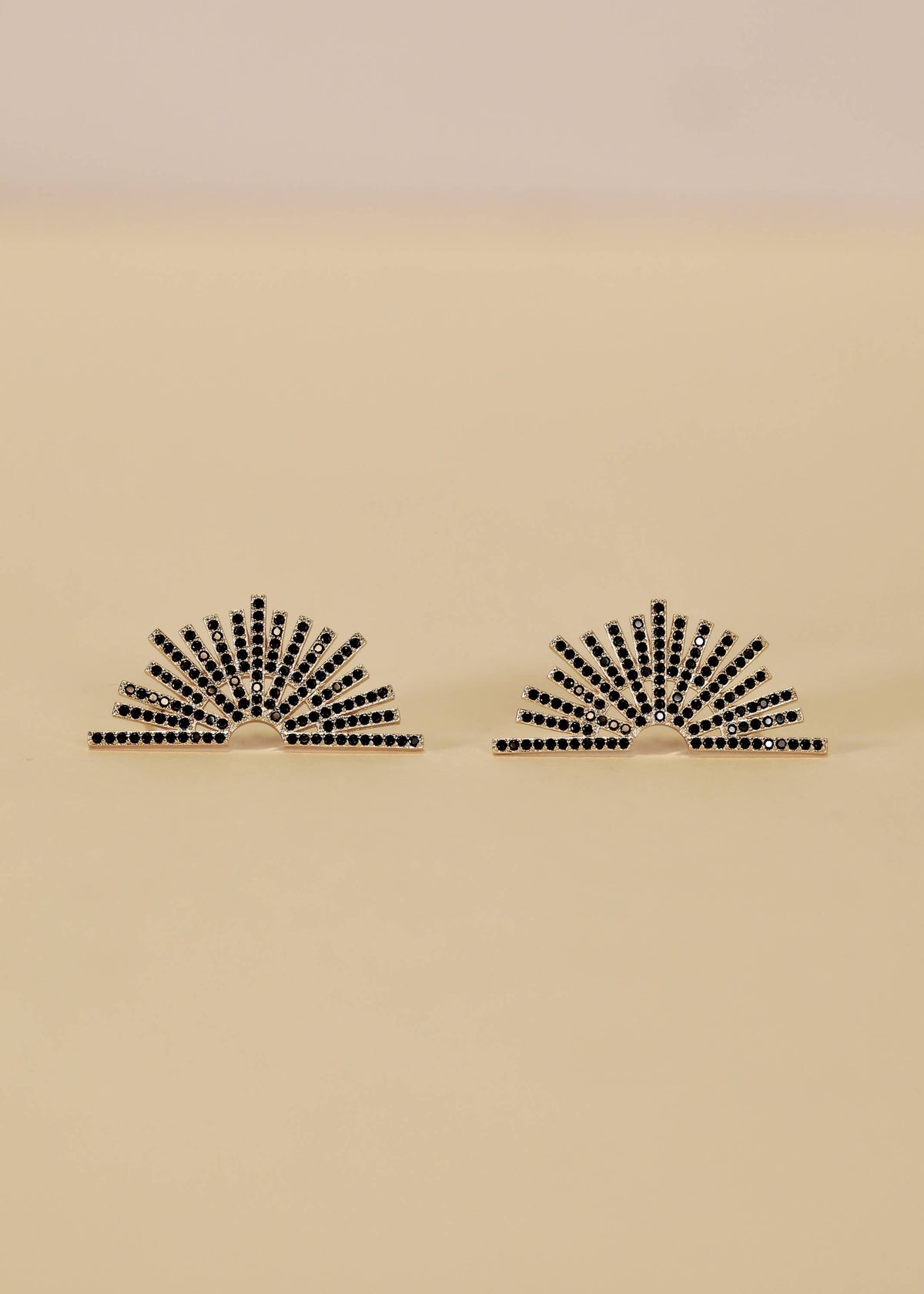 Jax Kelley Celestial Black Sunburst Gold Earrings featuring a sunburst design with black and gold accents.