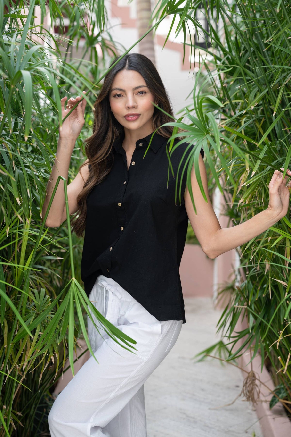 Black sleeveless top from Cotton Natural Aria collection, featuring a stylish design and casual fit.