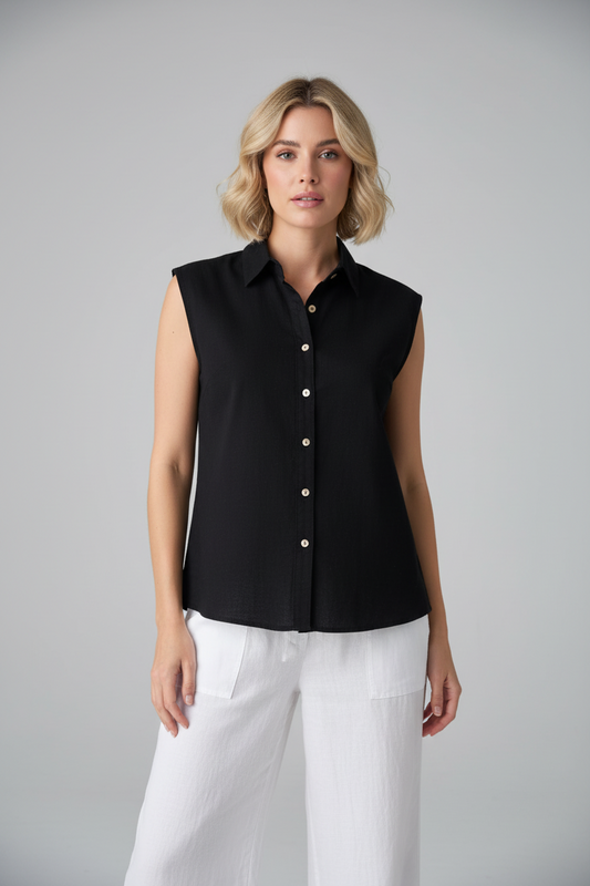 Black sleeveless top by Cotton Natural featuring a sleek design and fitted style, shown on a model.