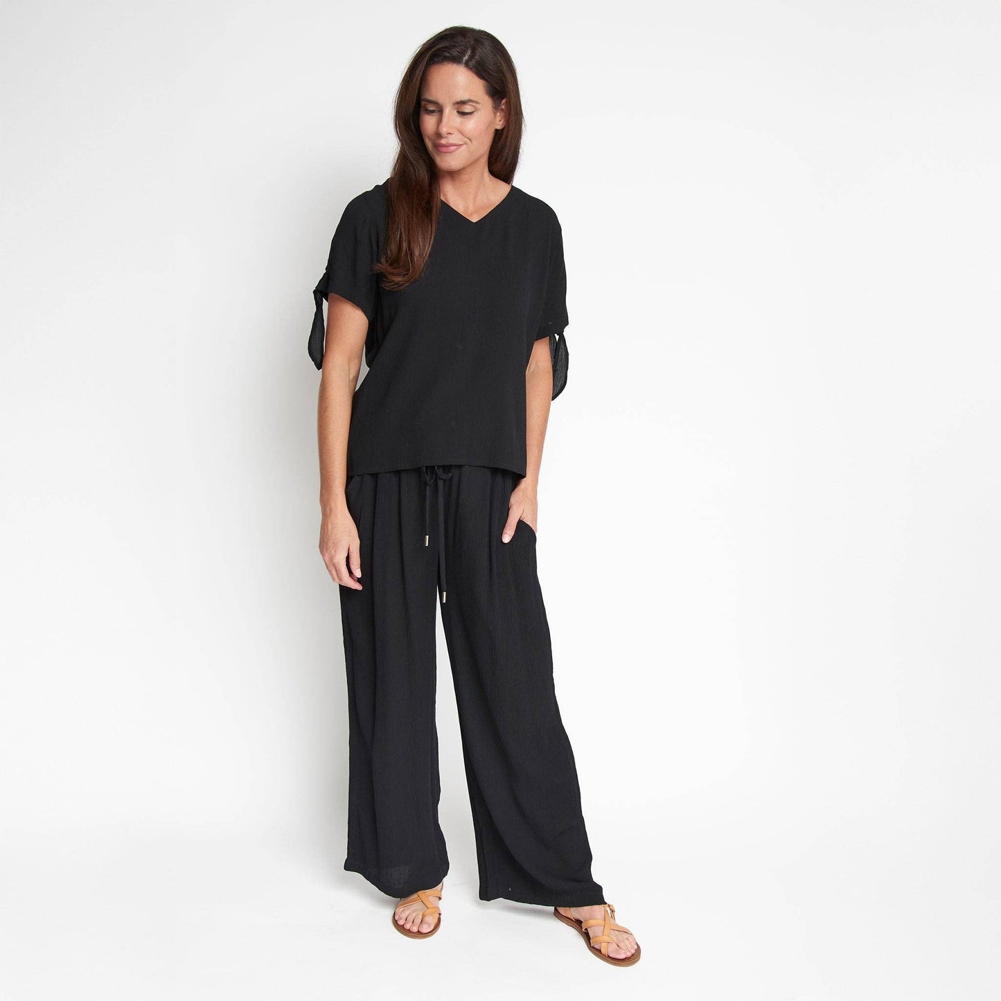 Elsie & Zoey Nika Crepe V-Neck Blouse with tied short sleeves, lightweight fabric, and stylish design, shown on a model.