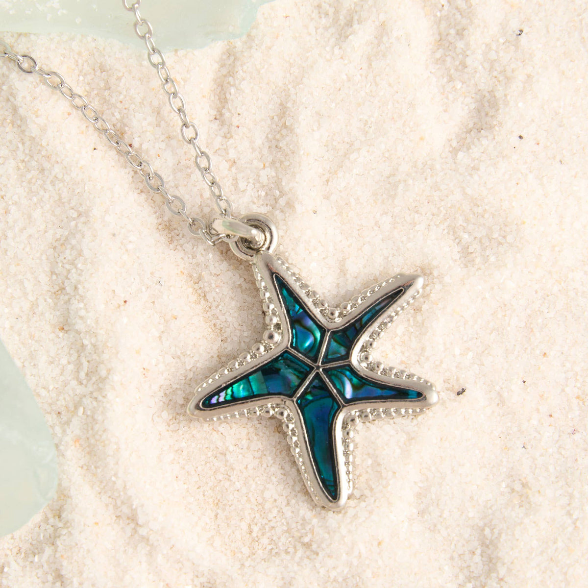 Howard's abalone shell starfish pendant necklace featuring a beach-inspired design with colorful, iridescent shell details.