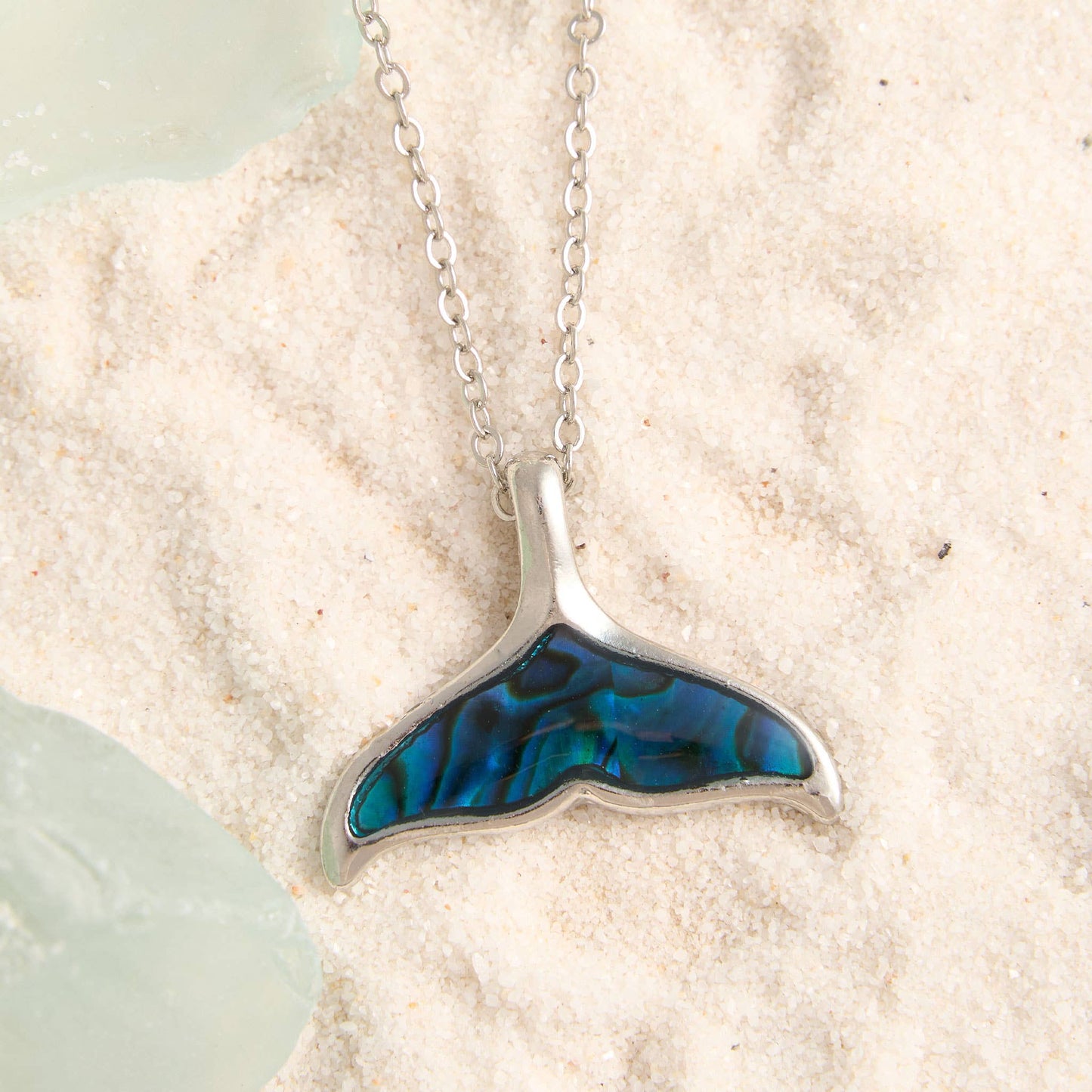 Howard's Abalone shell whale tail pendant necklace featuring beach-inspired jewelry with colorful, shiny shell details.