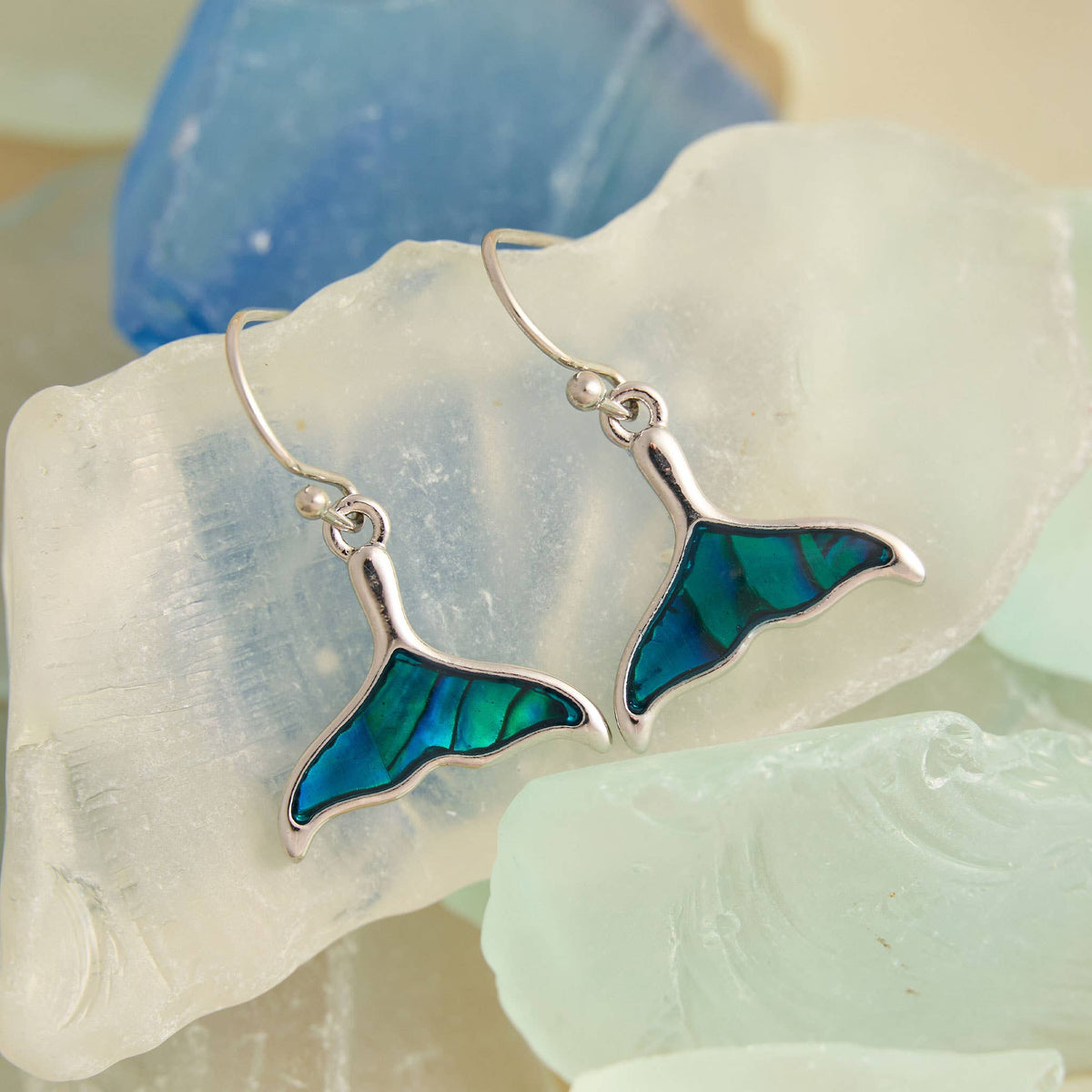 Blue whale tail earrings by Elsie & Zoey featuring abalone shell, beach jewelry style, with vibrant blue and iridescent details.