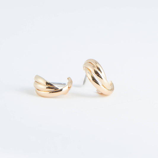 Pair of gold hoop earrings on a light gray background