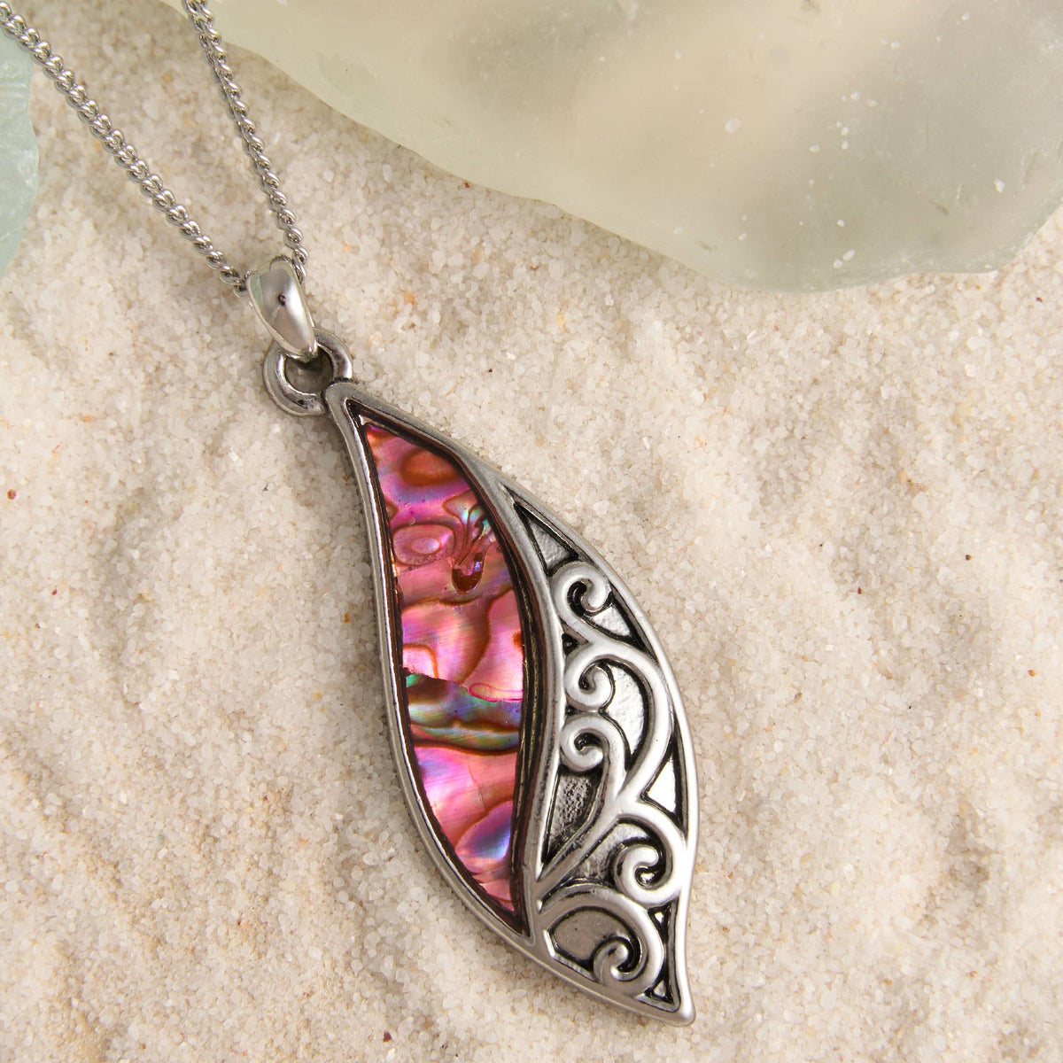 Howard's abalone shell curve pendant necklace featuring a polished, iridescent shell on a delicate chain, perfect beach jewelry.