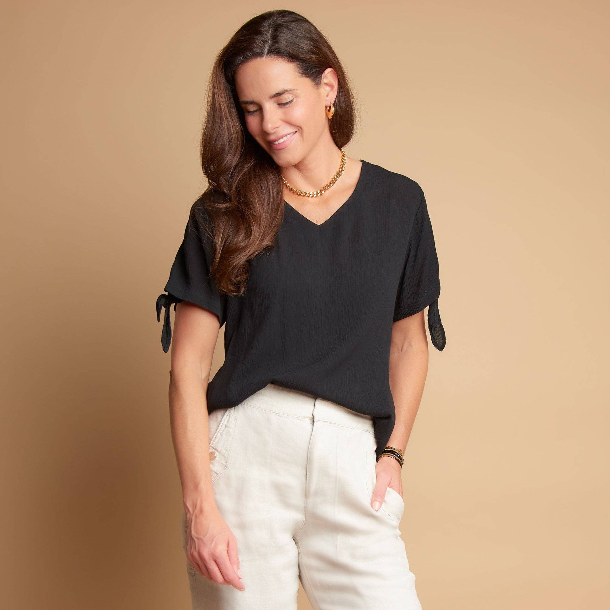 Elsie & Zoey Nika crepe tied short sleeve V-neck blouse, lightweight and stylish with a relaxed fit, shown in a natural pose.