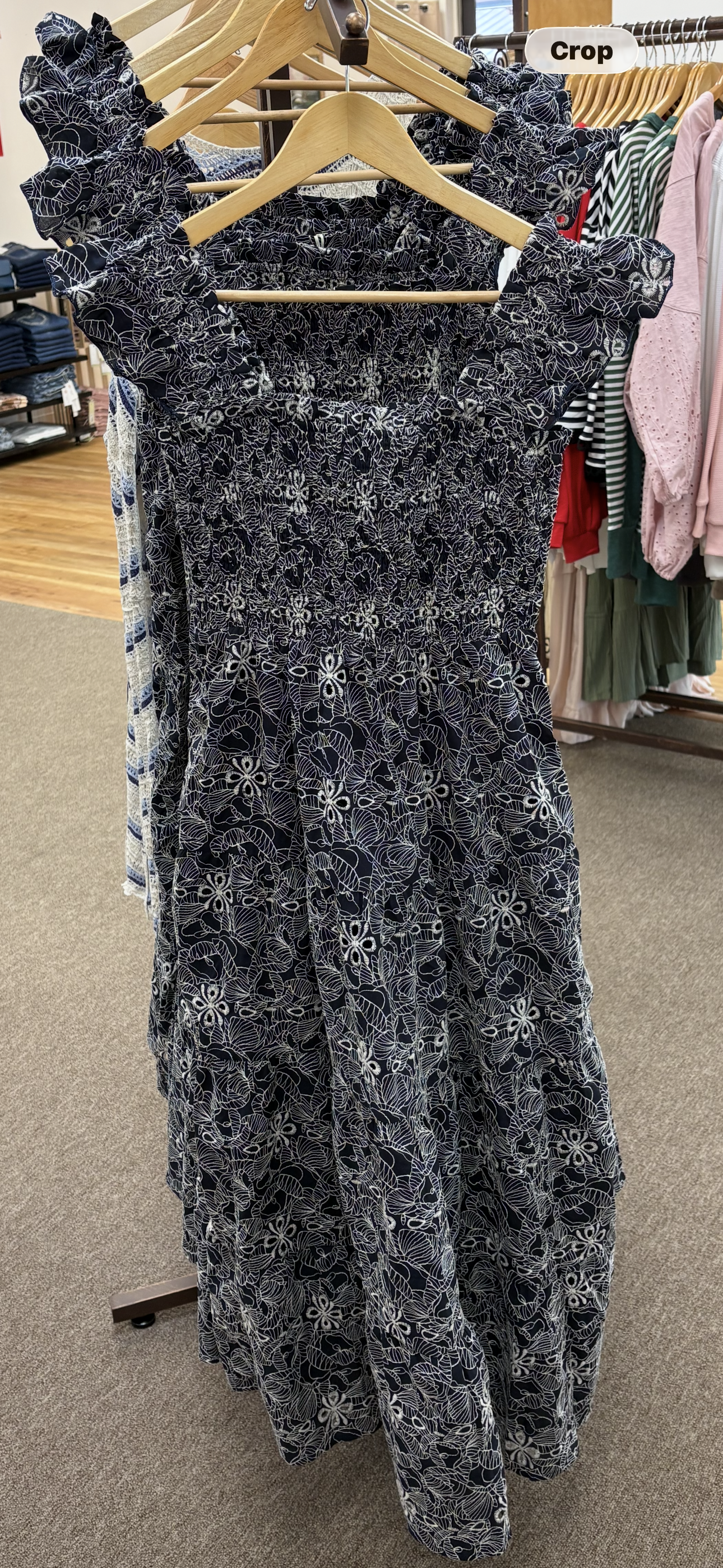 Navy embroidered smocked midi dress from Chic Speak Boutique featuring intricate embroidery and a fitted smocked bodice.