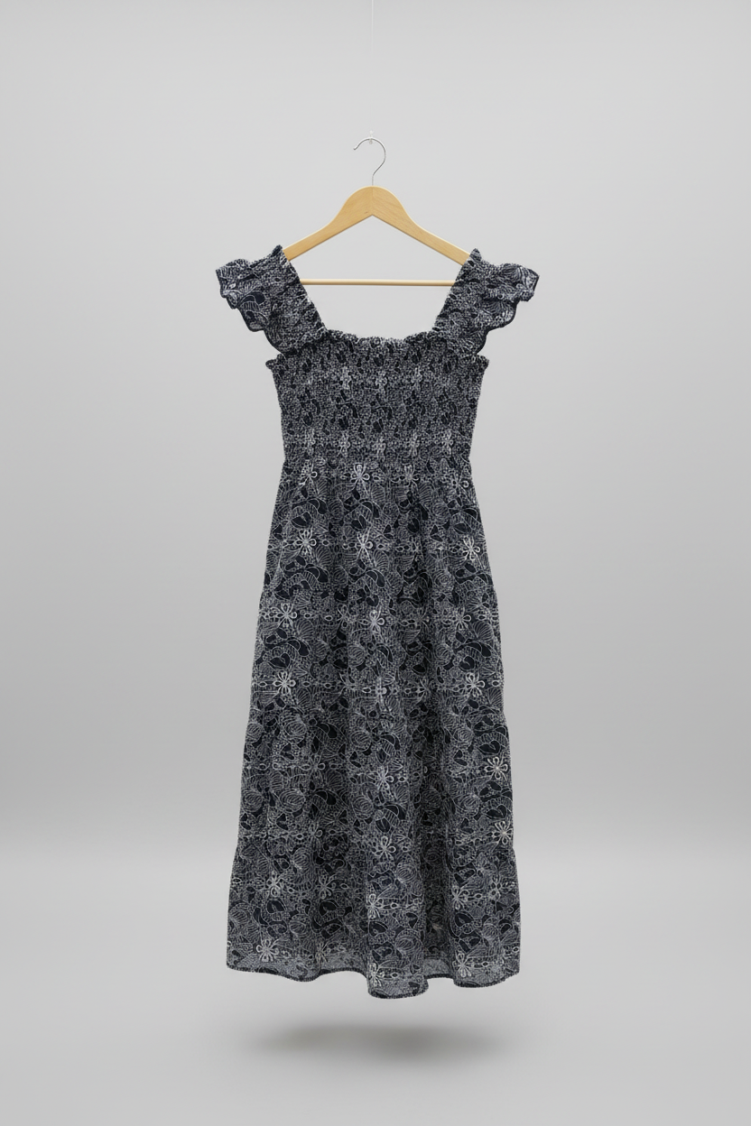 Navy embroidered smocked midi dress from Chic Speak Boutique with detailed embroidery and a fitted, feminine silhouette.