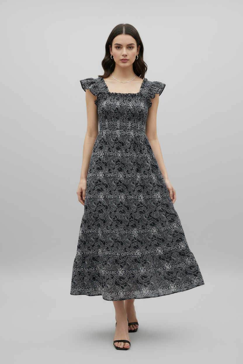 Navy embroidered smocked midi dress by Chic Speak Boutique, featuring floral embroidery and a flattering smocked bodice.