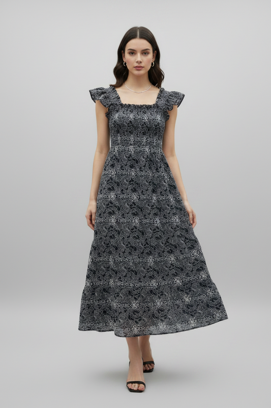 Navy embroidered smocked midi dress by Chic Speak Boutique, featuring floral embroidery and a flattering smocked bodice.