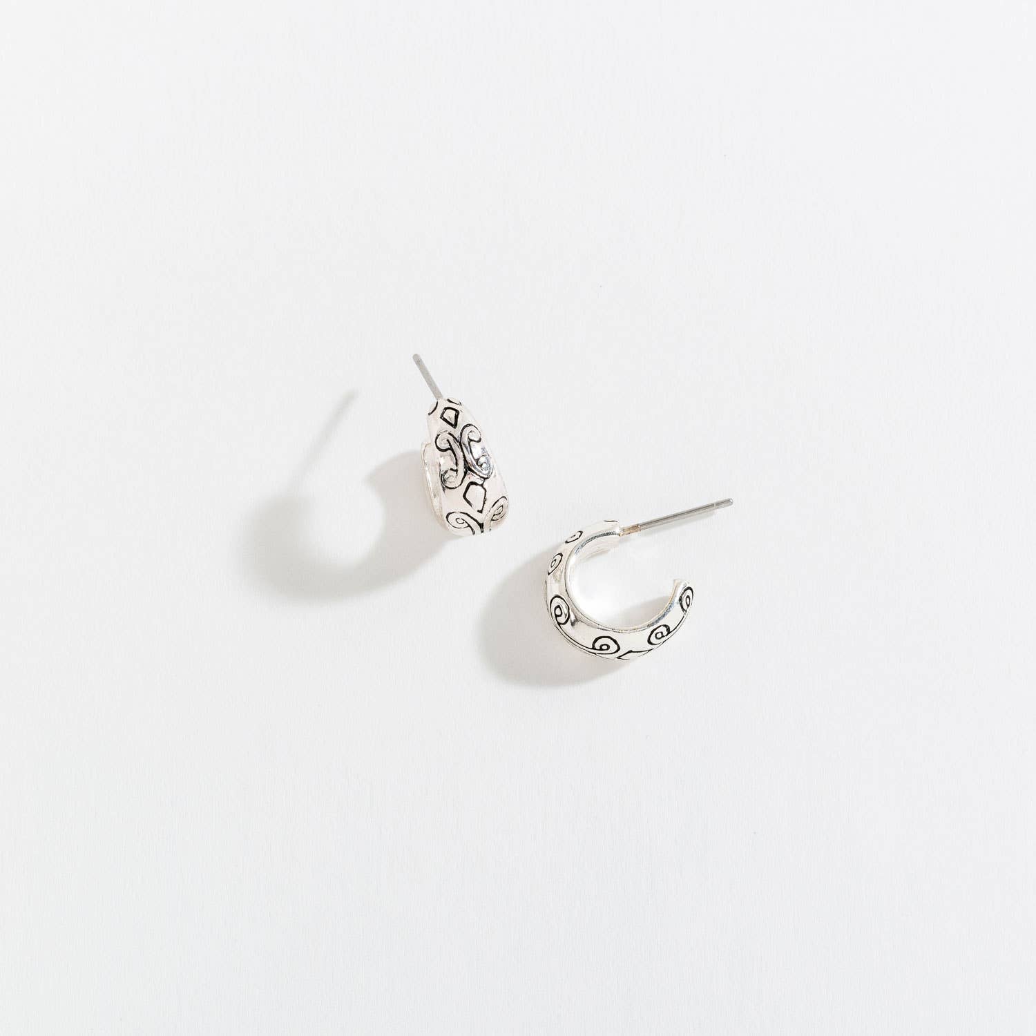 Antique silver hoop earrings from Howard's with a classic, elegant design and smooth finish, displayed on a plain background.