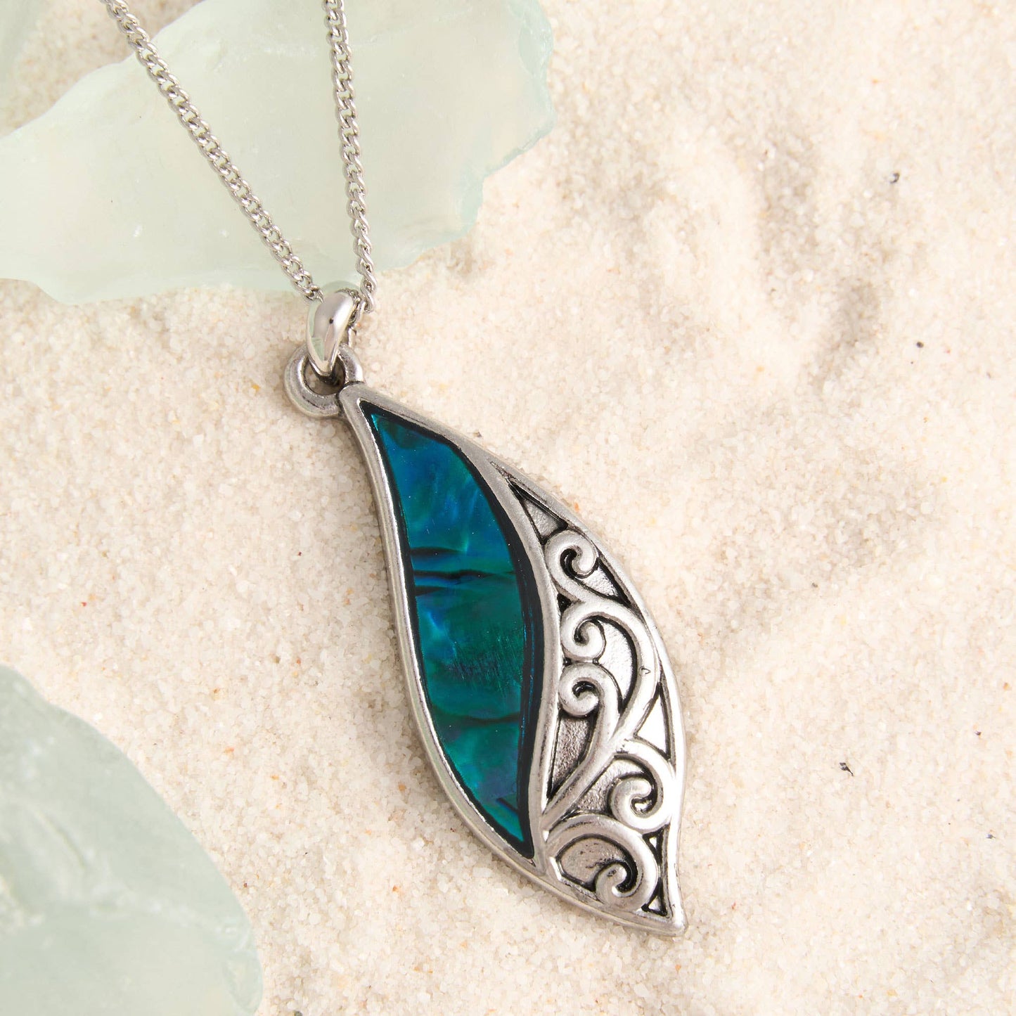 Howard's abalone shell curve pendant necklace featuring a glossy, colorful abalone shell with a sleek silver chain.
