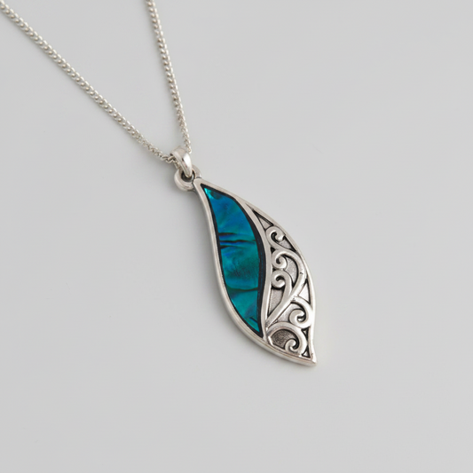 Howard's abalone shell curve pendant necklace featuring a natural beach-inspired design on a silver chain.