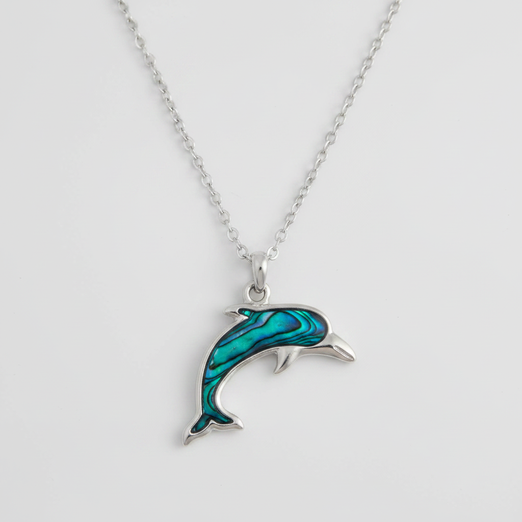 Dolphin-shaped pendant on a chain against a light gray background