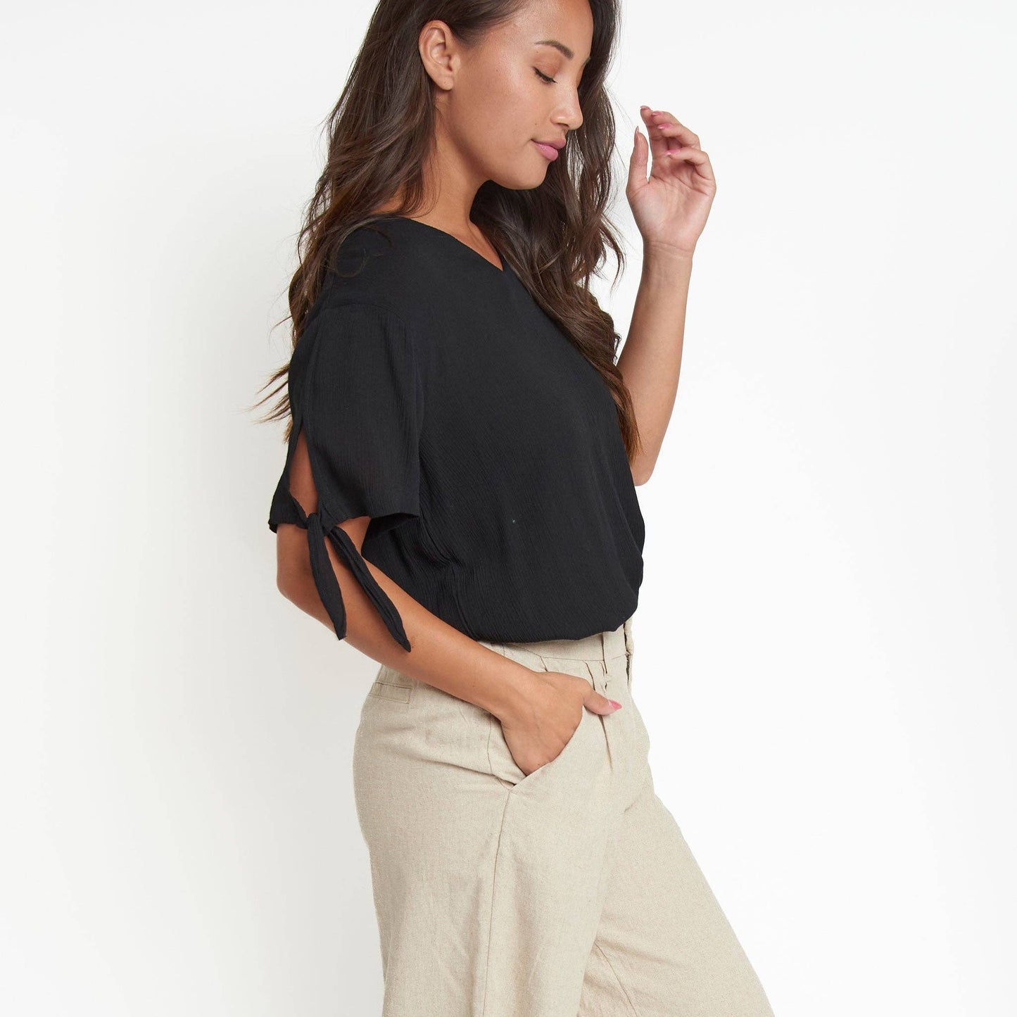 Elsie & Zoey Nika crepe short sleeve V-neck blouse with tie-front design, lightweight fabric, and relaxed fit.