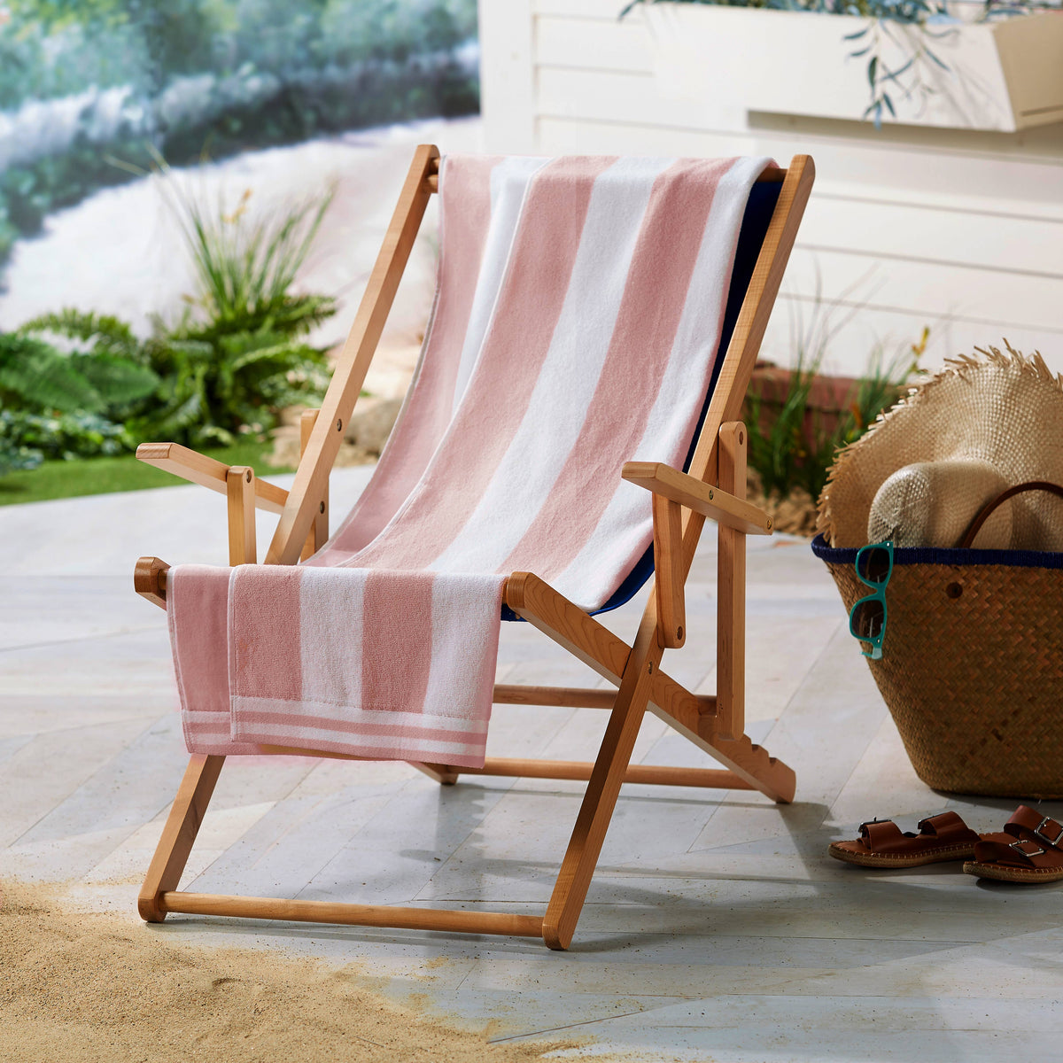 Oversized striped cabana beach towel by BH Collective featuring colorful horizontal stripes, perfect for seaside lounging.