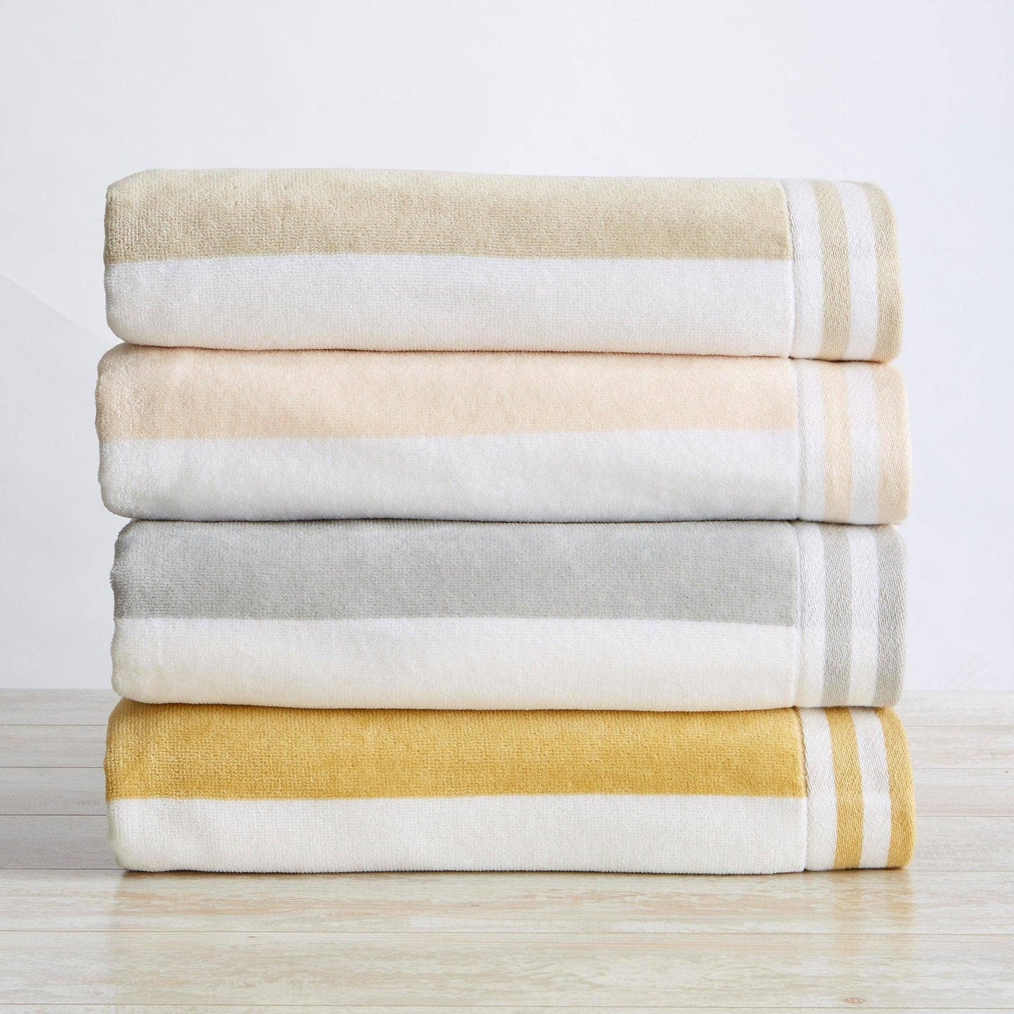 Striped Cabana Oversized Beach Towel by BH Collective, showing soft, colorful fabric with bold stripe pattern for beach or pool use.