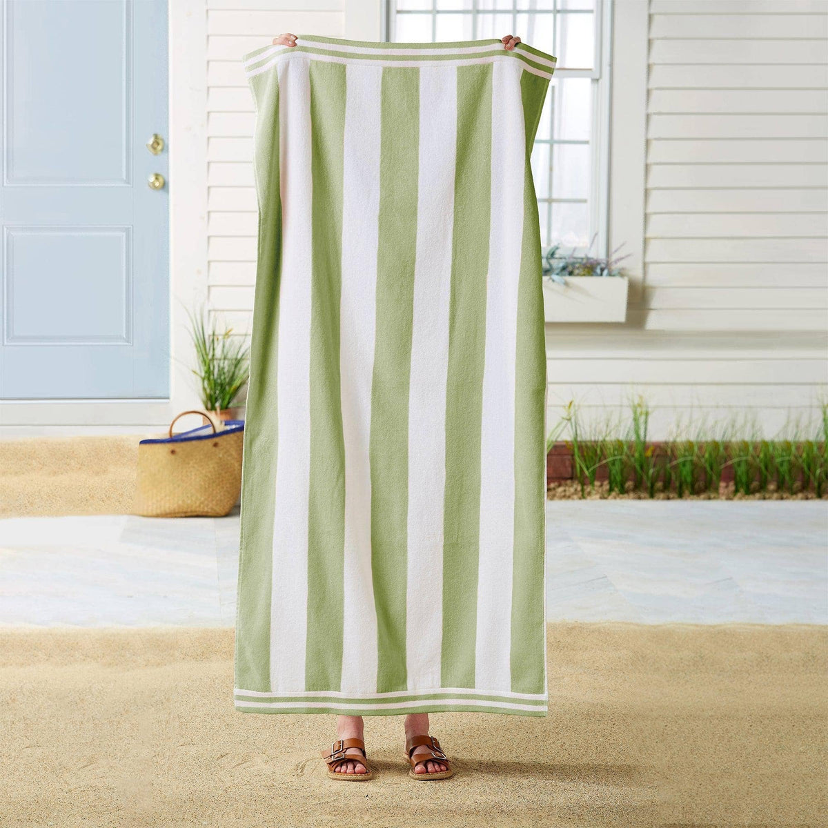 Large striped cabana beach towel by BH Collective featuring bold colorful stripes, perfect for seaside lounging.