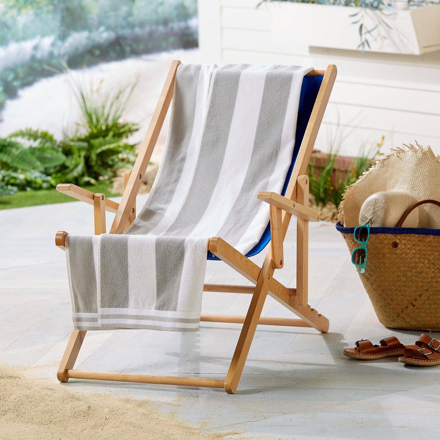 Bright striped Edgartown cabana oversized beach towel by BH Collective laid out on sand.
