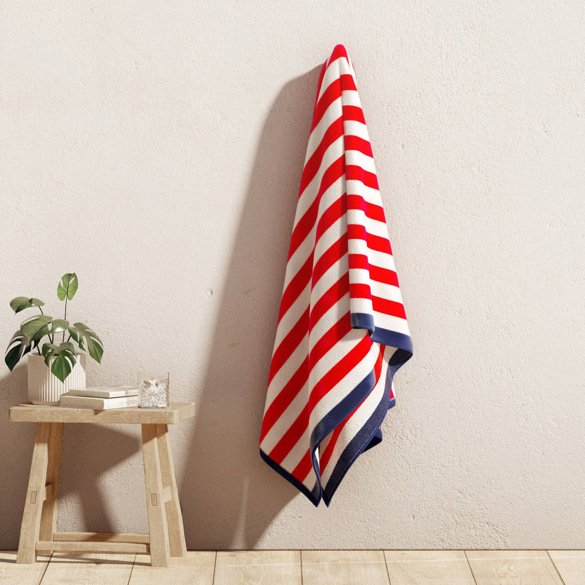 BH Collective oversized striped border Cabana beach towel featuring vibrant colors and a large, comfortable design for beach use.