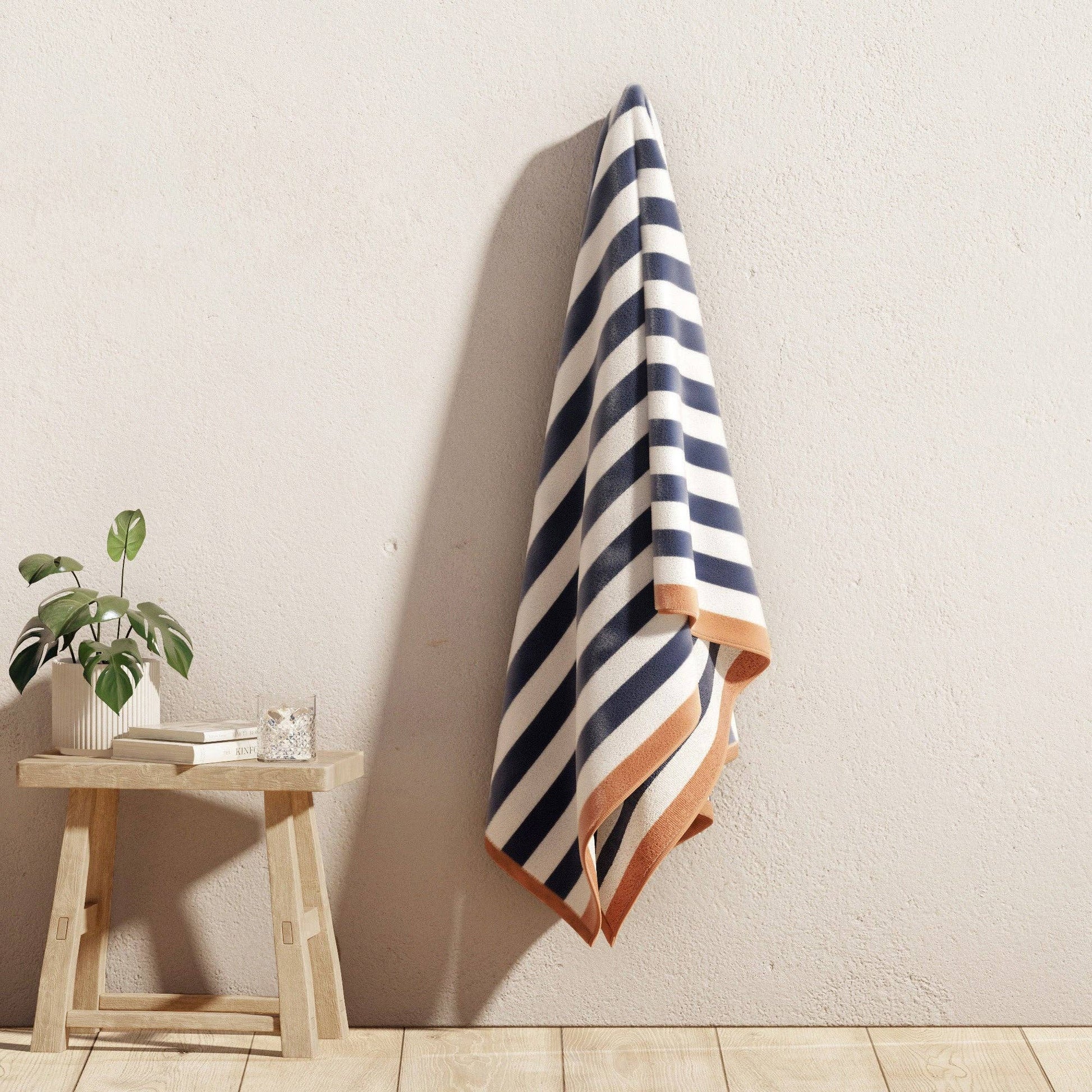 Oversized Santa Cruz striped border cabana beach towel by BH Collective, featuring vibrant colorful stripes on soft terry fabric.