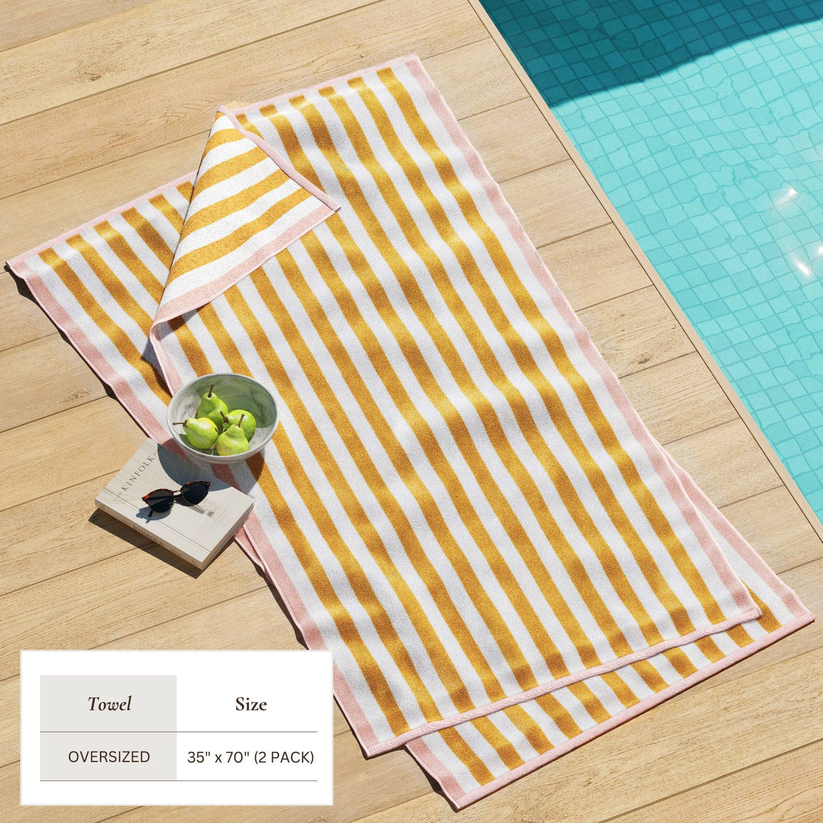 BH Collective oversized striped border Cabana Beach Towel in Santa Cruz with vibrant stripes on soft fabric, perfect for beach days.