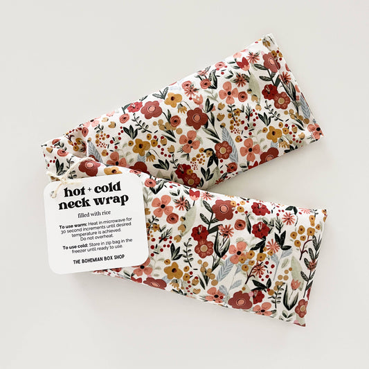 Bohemian Box Shop Earth Botanicals hot and cold therapy neck wrap with floral design and adjustable strap for soothing relief.