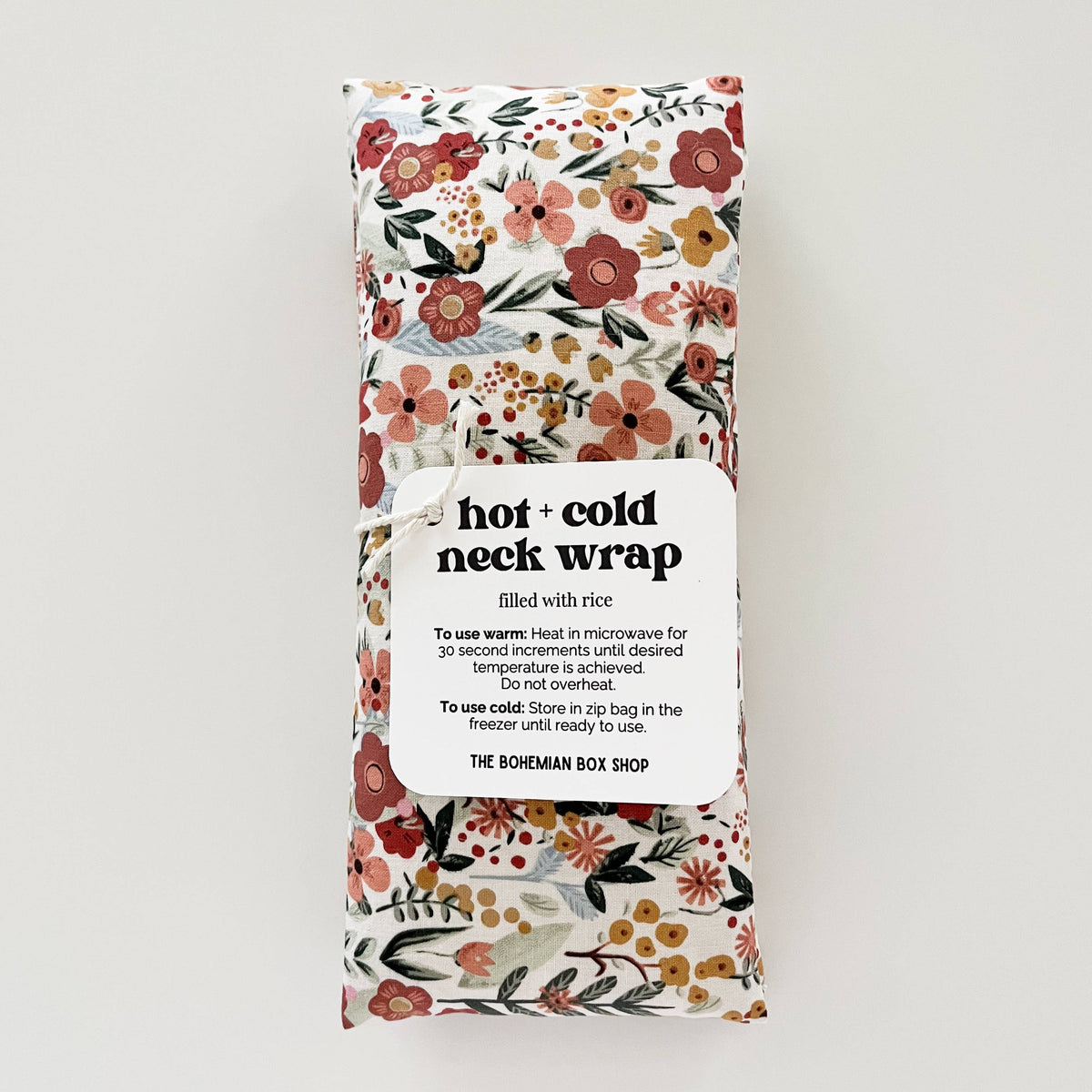 Earth Botanicals hot and cold therapy neck wrap showing soft fabric and adjustable strap for soothing neck relief.