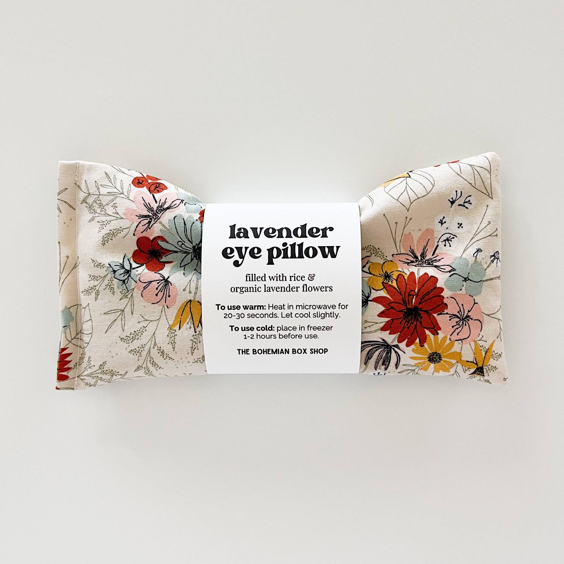 Lavender eye pillow with ivory floral pattern from Bohemian Box Shop, soft fabric and soothing design for relaxation.
