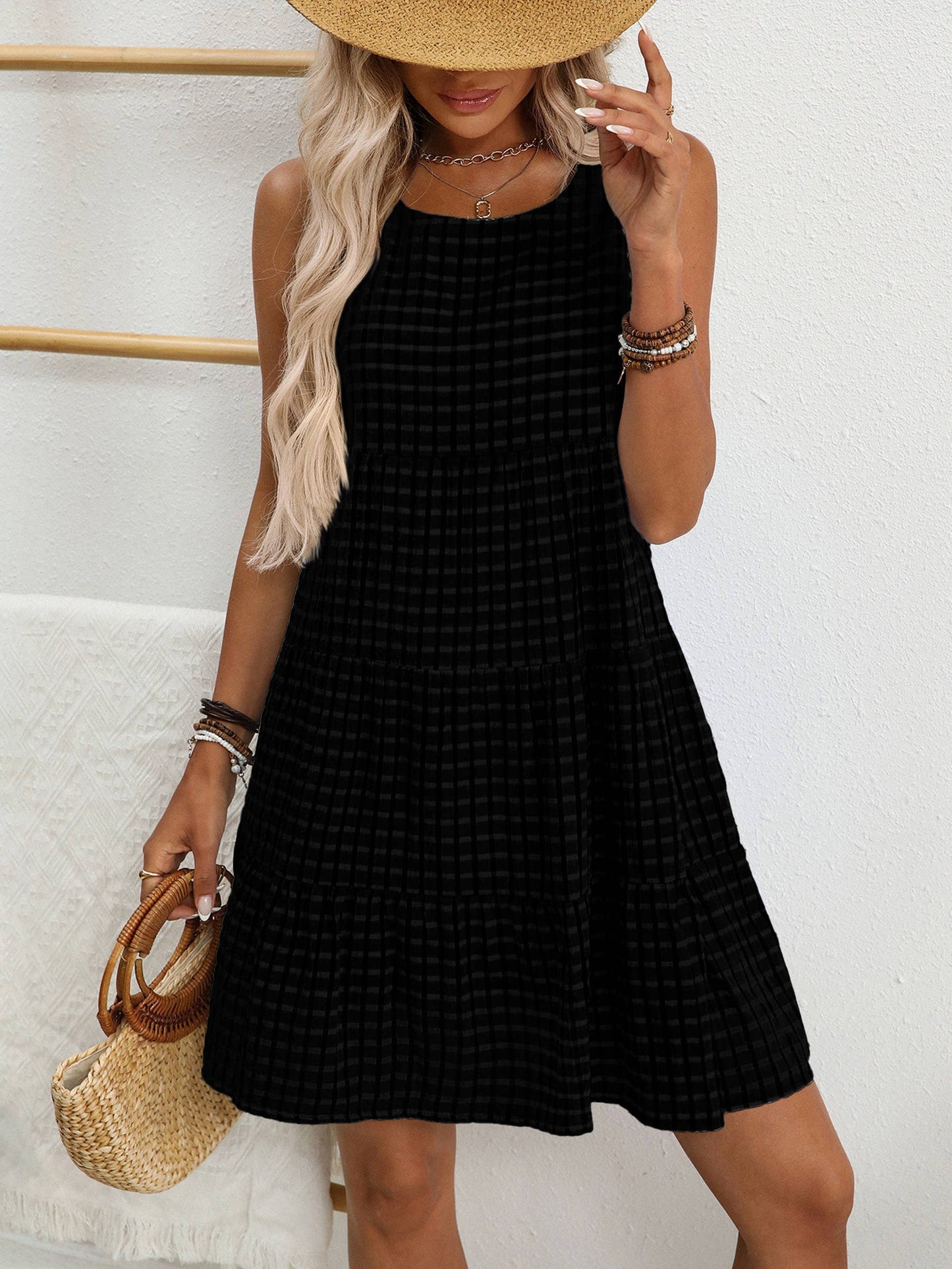 Sleeveless plaid dress by Wholesalesir featuring a classic checkered pattern and a fitted silhouette on a model.