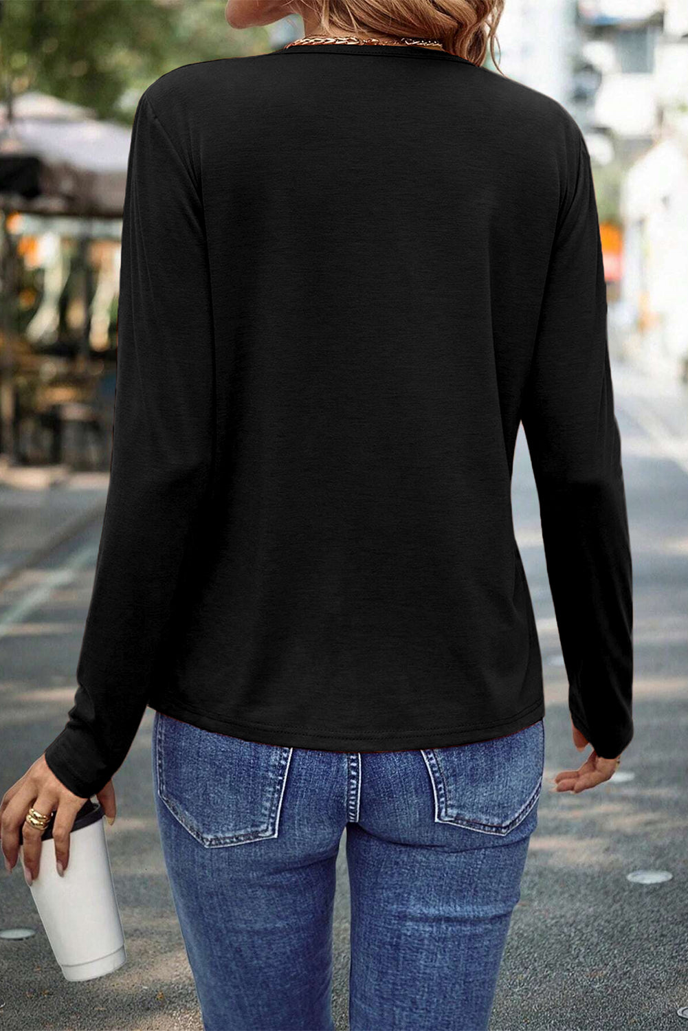 Black asymmetric seam detail long-sleeve top from Chic Speak Boutique with stylish, modern design and unique seam accents.