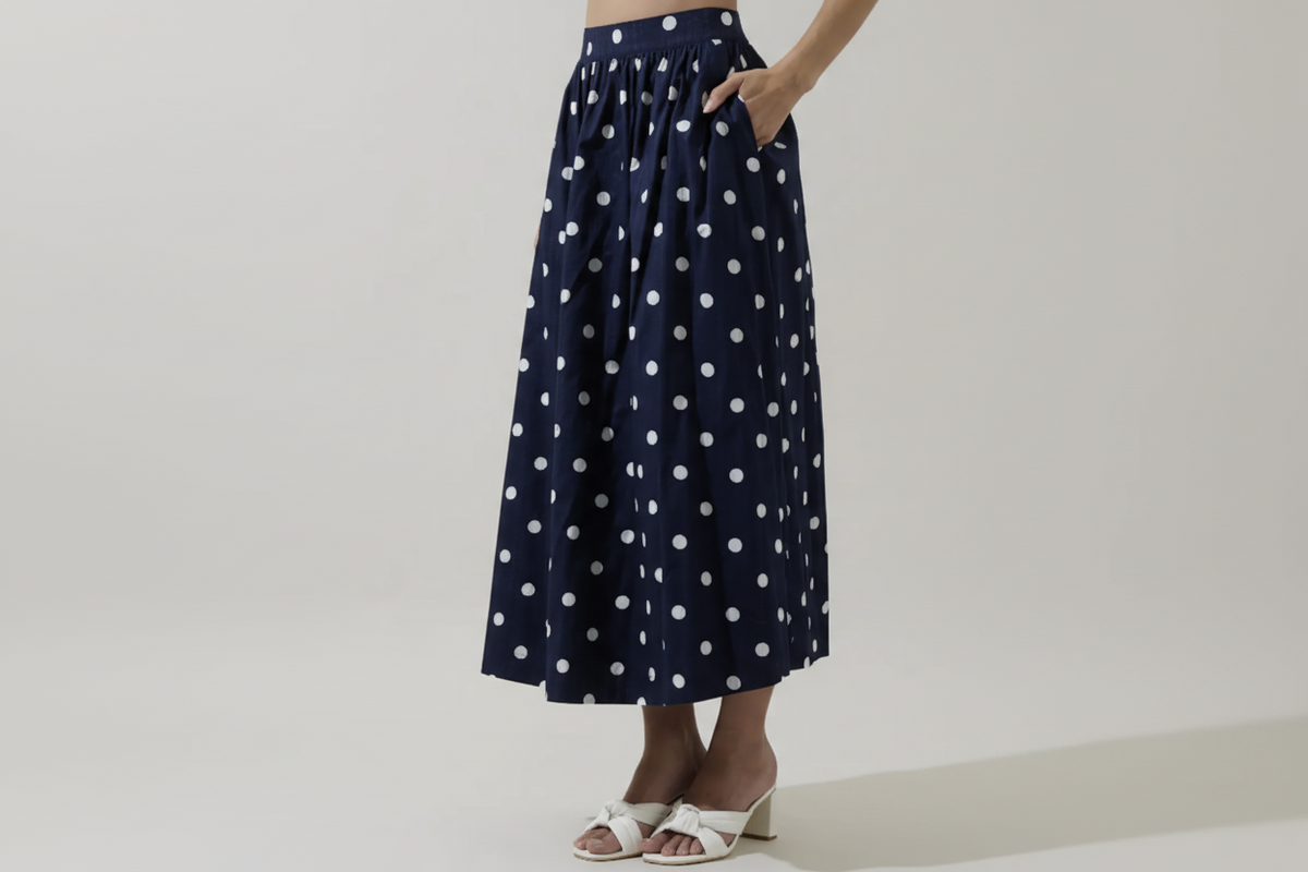 Caryn polka dot skirt by SugarLips featuring a flowy design with black and white dots, styled with a casual top.