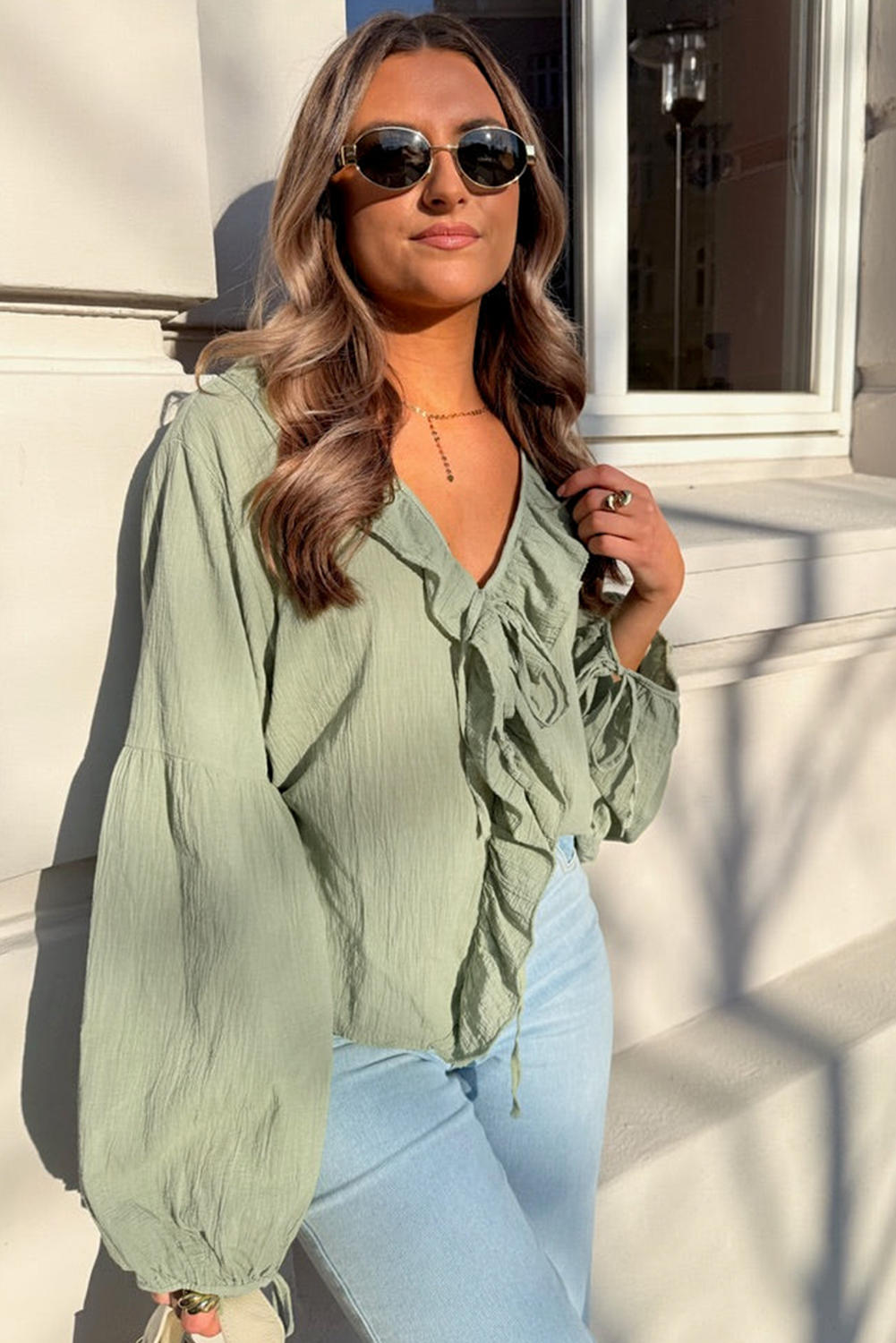 Mist Green ruffle trim V-neck blouse from Chic Speak Boutique, featuring soft fabric and feminine ruffle details.