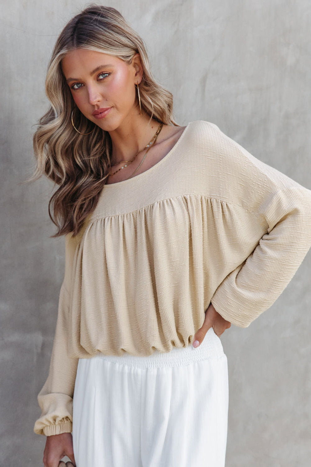 Chic Speak Boutique pleated long sleeve top in soft fabric, featuring a structured design and elegant detailing.