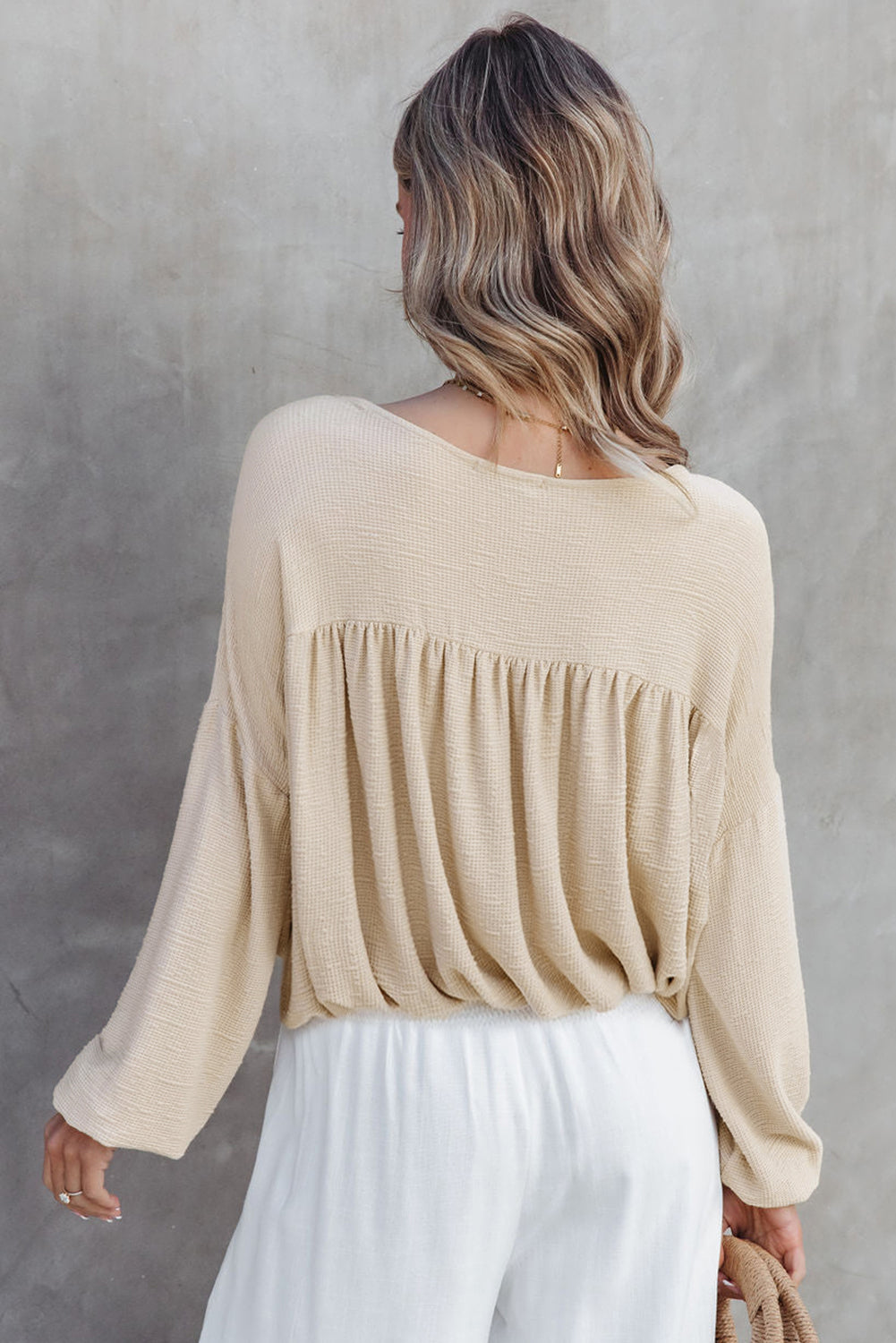 Pleated long sleeve top from Chic Speak Boutique, with a stylish fit and elegant design, shown on a neutral background.