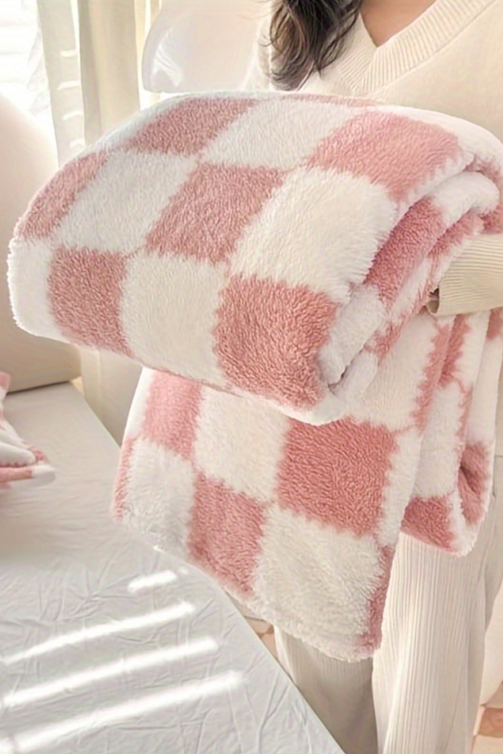 Pink checkered blanket from Chic Speak Boutique, soft woven fabric with a stylish pattern perfect for cozy home decor.