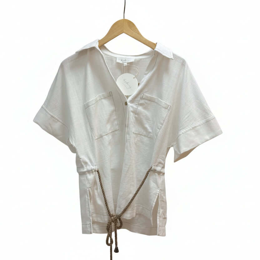 Cotton linen drawstring shirt from Chic Speak Boutique featuring a relaxed fit and adjustable waist, in neutral tones.