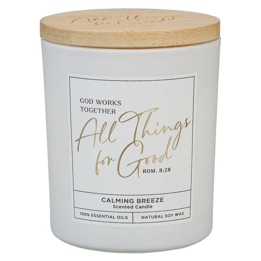 White glass candle with wooden bamboo lid featuring Christian Art Gifts logo, inspired by Romans 8:28 scripture.