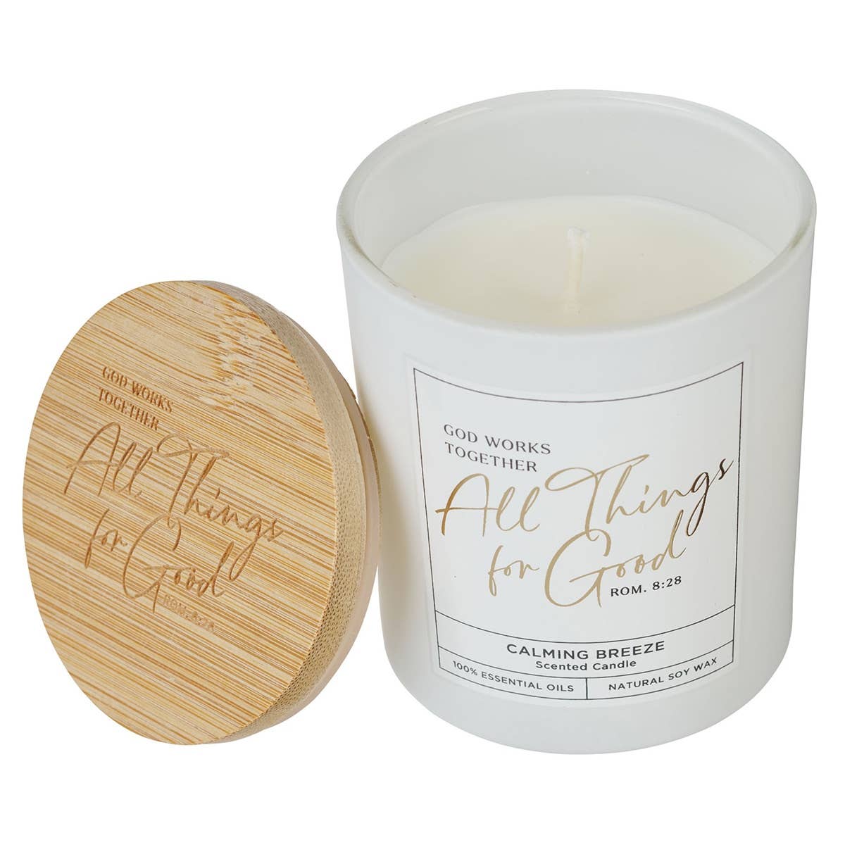 White glass candle with bamboo lid and Christian Art Gifts label featuring Bible verse Romans 8:28, designed for spiritual inspiration.