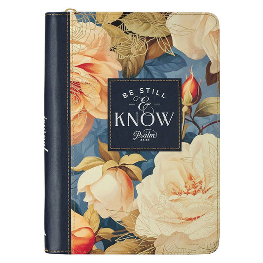 Christian Art Gifts navy leather journal with "Be Still" Psalm 46:10 inscription and zip closure, designed for spiritual reflection.