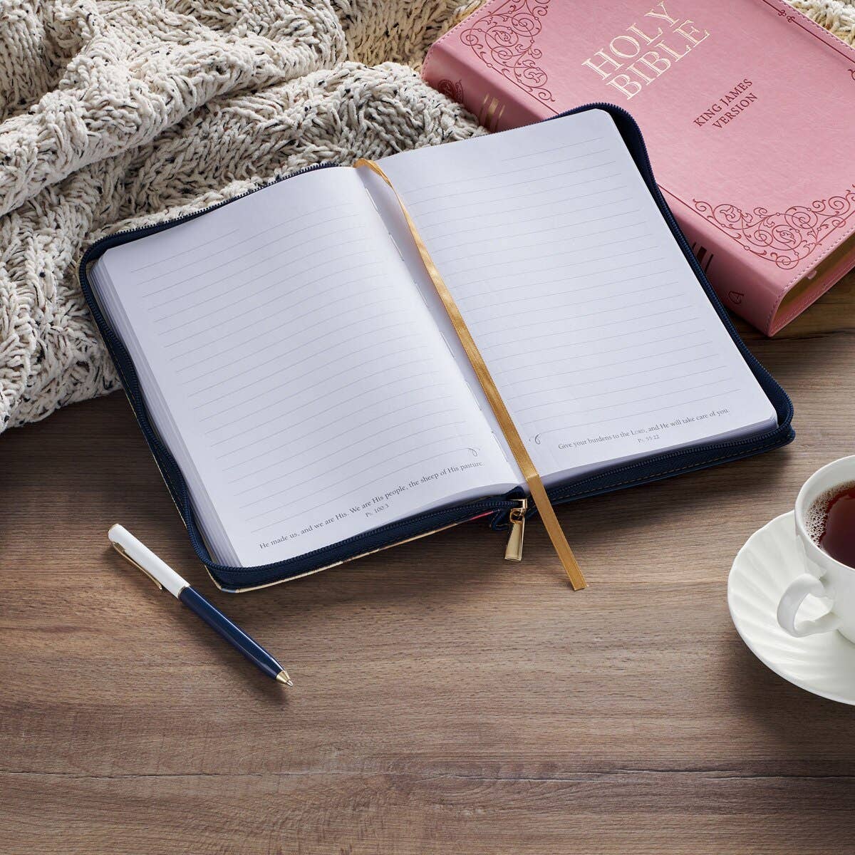 Christian Art Gifts navy journal with zip closure featuring Psalm 46:10, "Be Still," on the cover. Classic Christian-themed design.