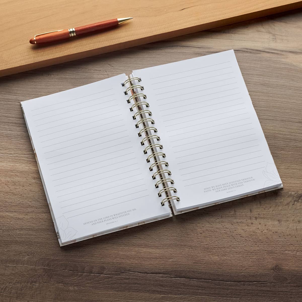 Wirebound white floral journal with Christian Art Gifts branding, featuring "All Things For Good" scripture from Romans 8:27.