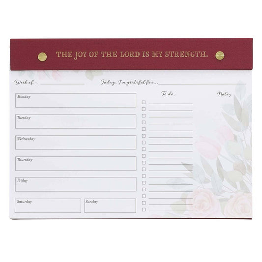 Undated planner pad in burgundy with "Joy of the Lord" Christian Art Gifts branding, featuring daily planning pages and decorative design.