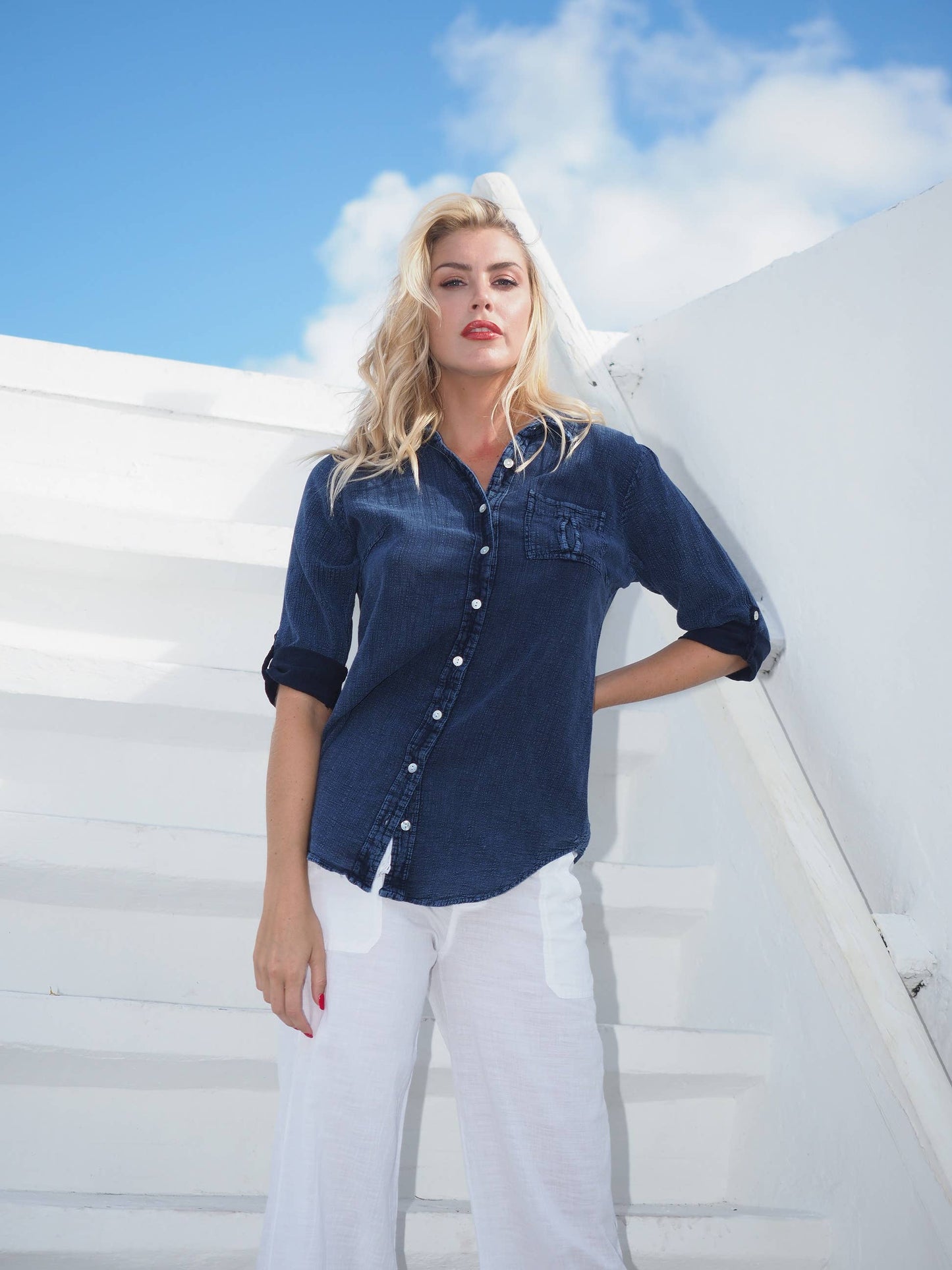 Kate Midnight Blue Shirt by Cotton Natural, featuring a classic button-up design, shown on a hanger against a plain background.
