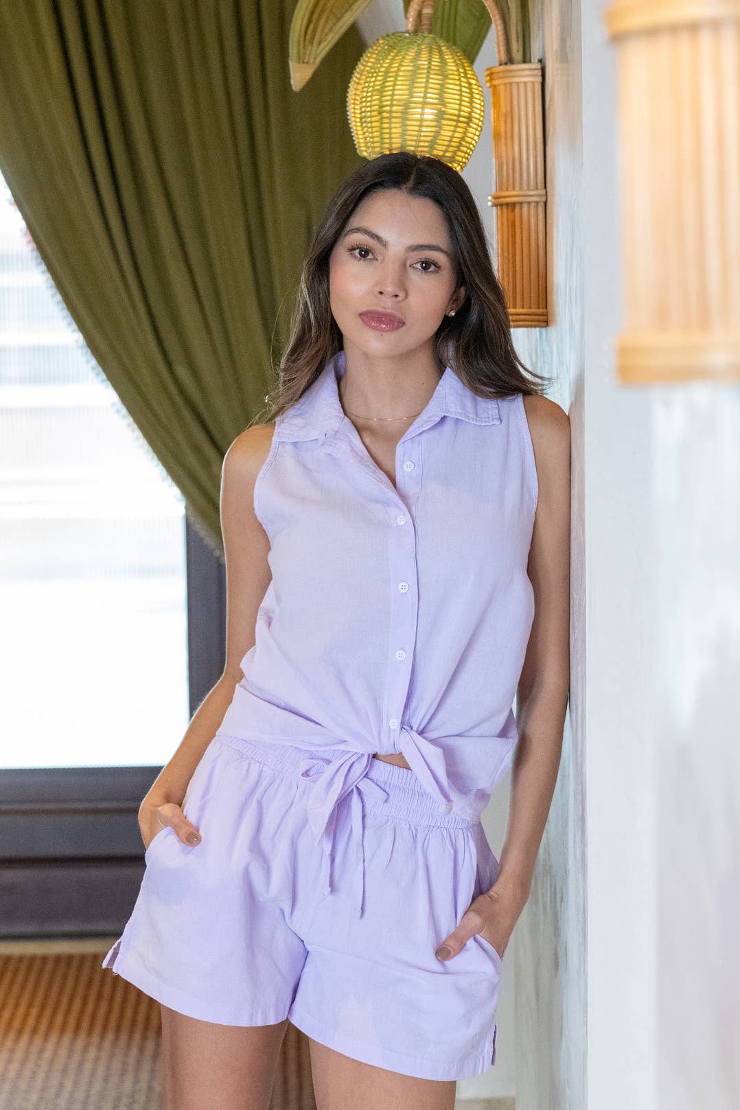 Astra Women's sleeveless high-low cotton top from Cotton Natural, featuring a button-up front and relaxed fit.